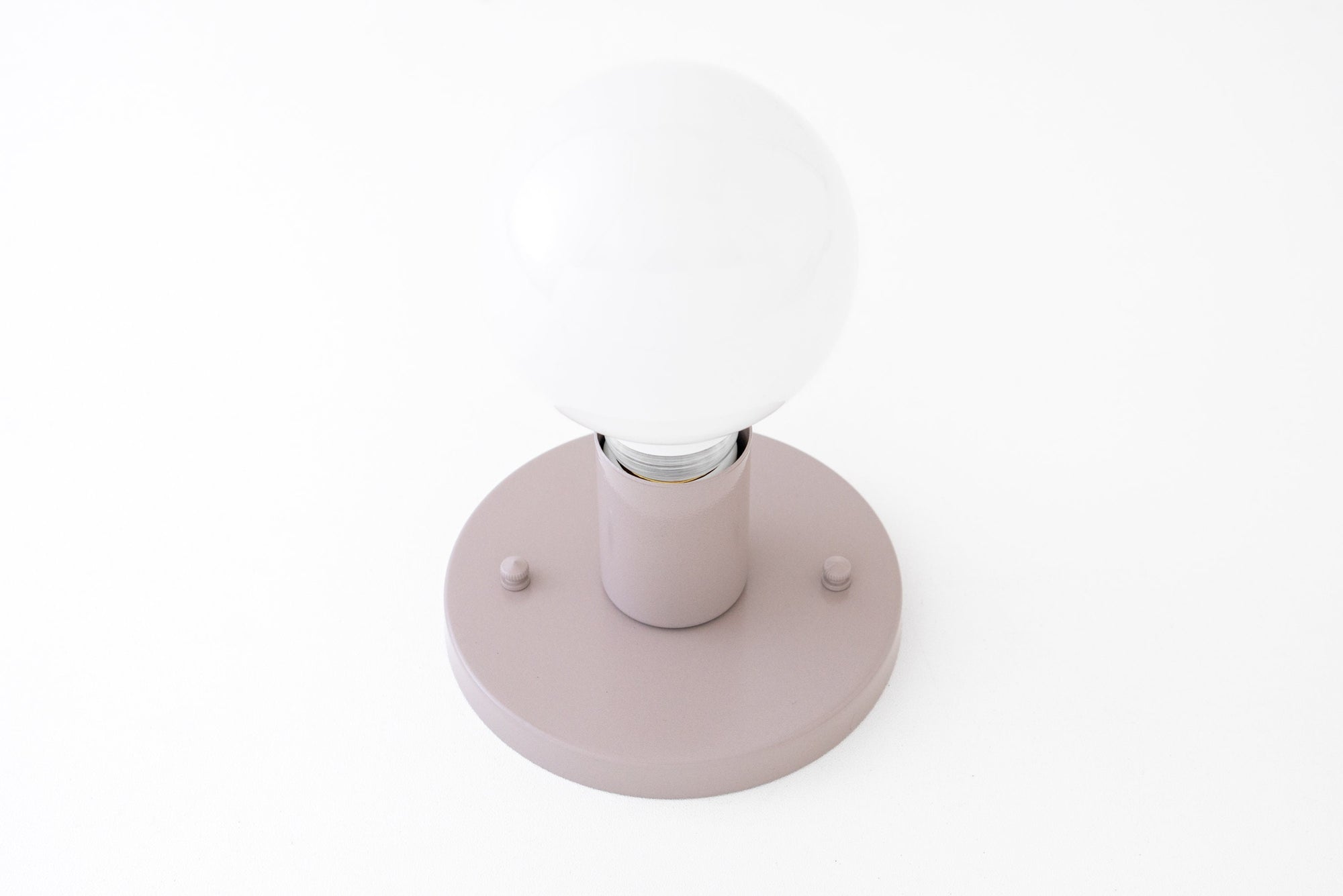 Mauve matte flush mount sconce with round white opaque bulb and minimal hardware. - SCONCE MODEL NO. 4460
