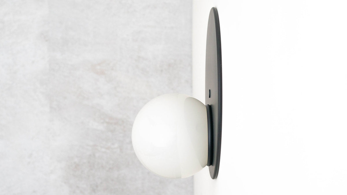Mid-century modern black metal flush sconce with white spherical globe light. - SCONCE MODEL NO. 6703