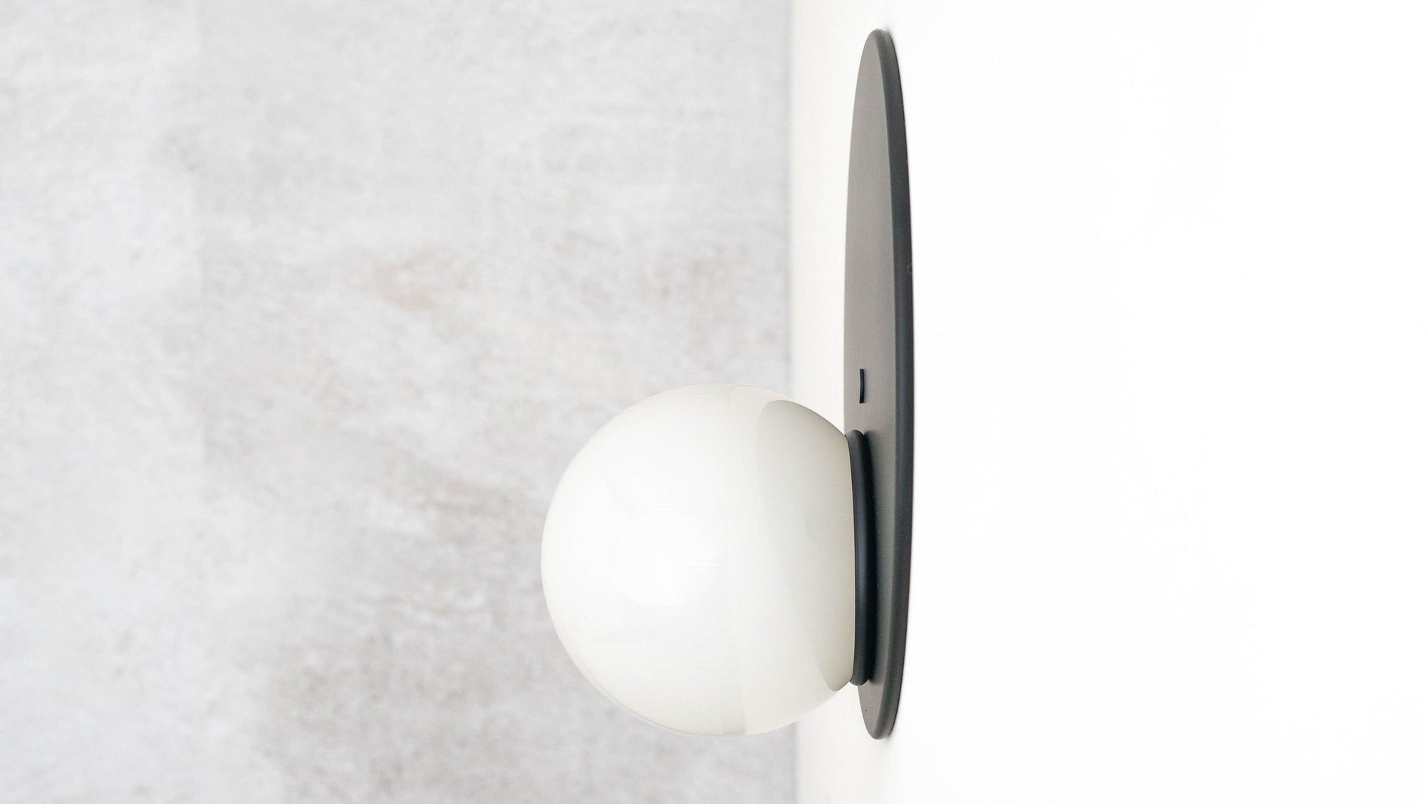 Mid-century modern black metal flush sconce with white spherical globe light. - SCONCE MODEL NO. 6703