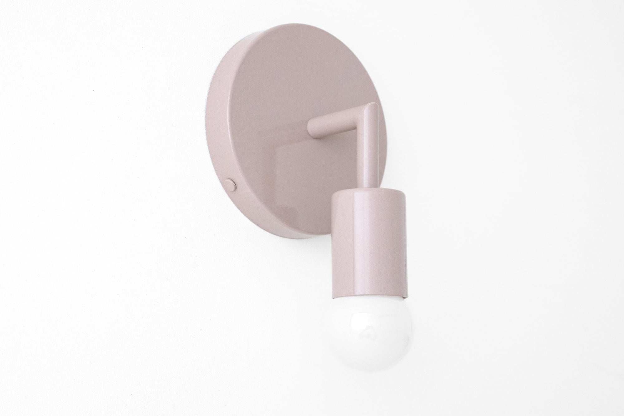 Matte white Scandinavian-style wall sconce with bare bulb and round backplate. - SCONCE MODEL NO. 5480