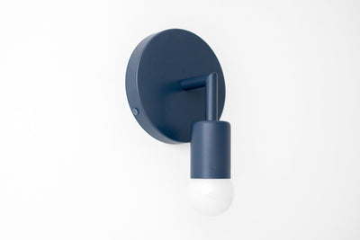 Matte coal blue Scandinavian sconce with round base and exposed bulb design. - SCONCE MODEL NO. 5480