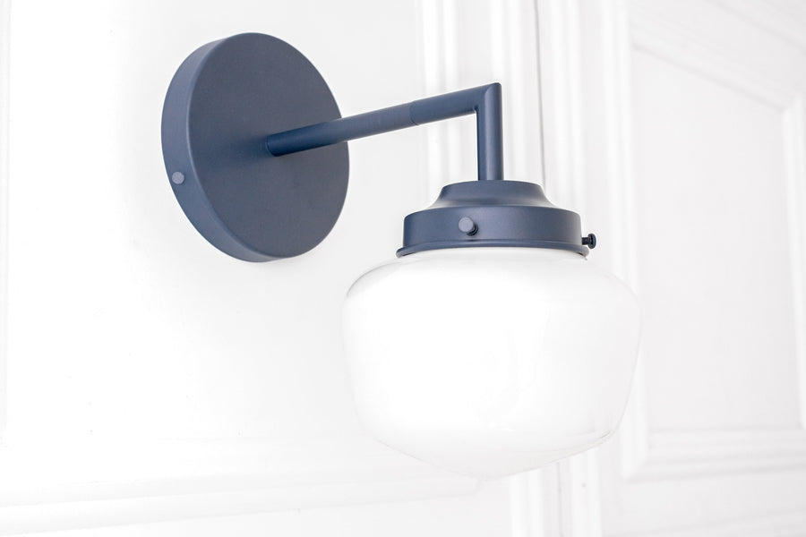 Matte black metal Art Deco wall sconce with white globe shade and round backplate. - SCONCE MODEL NO. 4260
