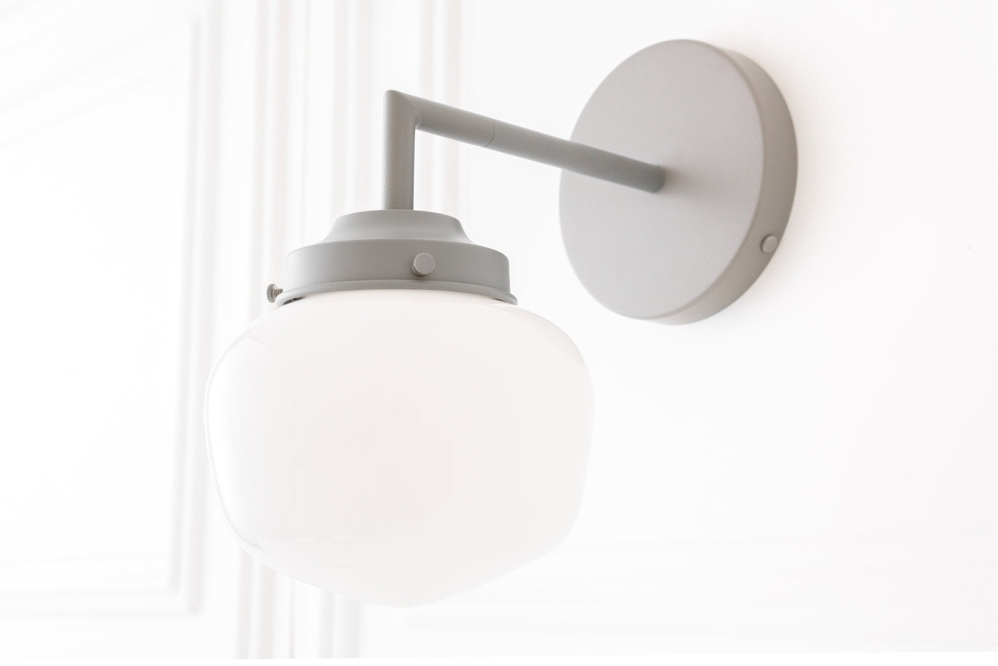 Matte white metal wall sconce with frosted white glass globe shade and straight arm mount. - SCONCE MODEL NO. 4260