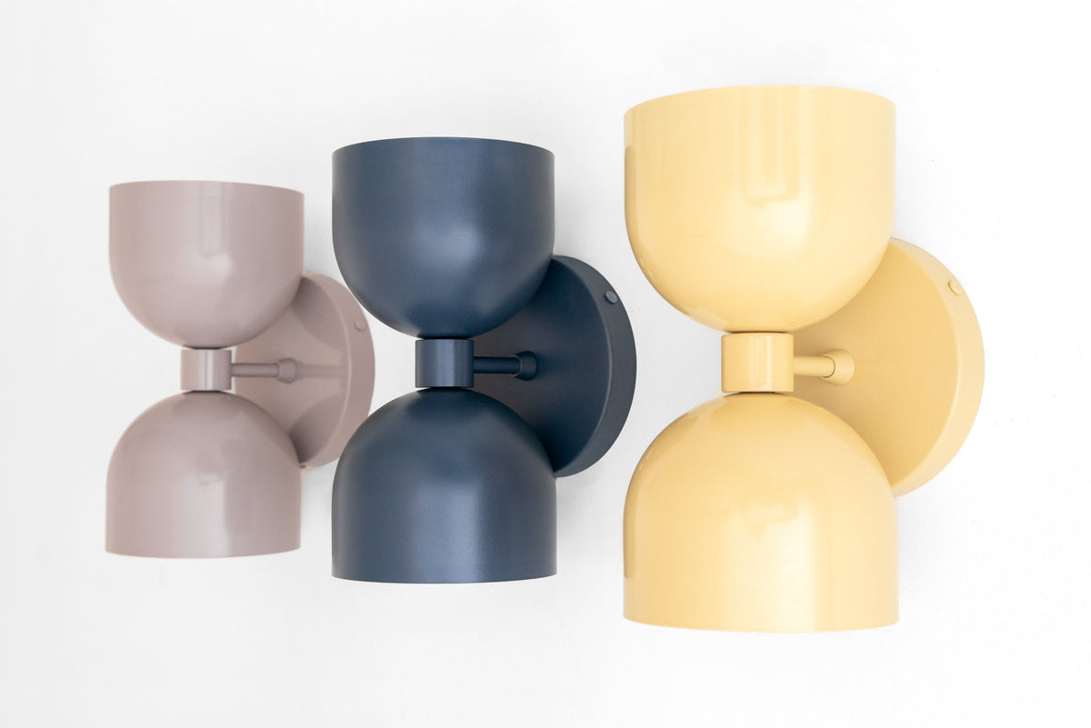 Three modern double-shade sconces in mauve, coal blue, and yellow with matte finish and round backplates. - SCONCE MODEL NO. 5641