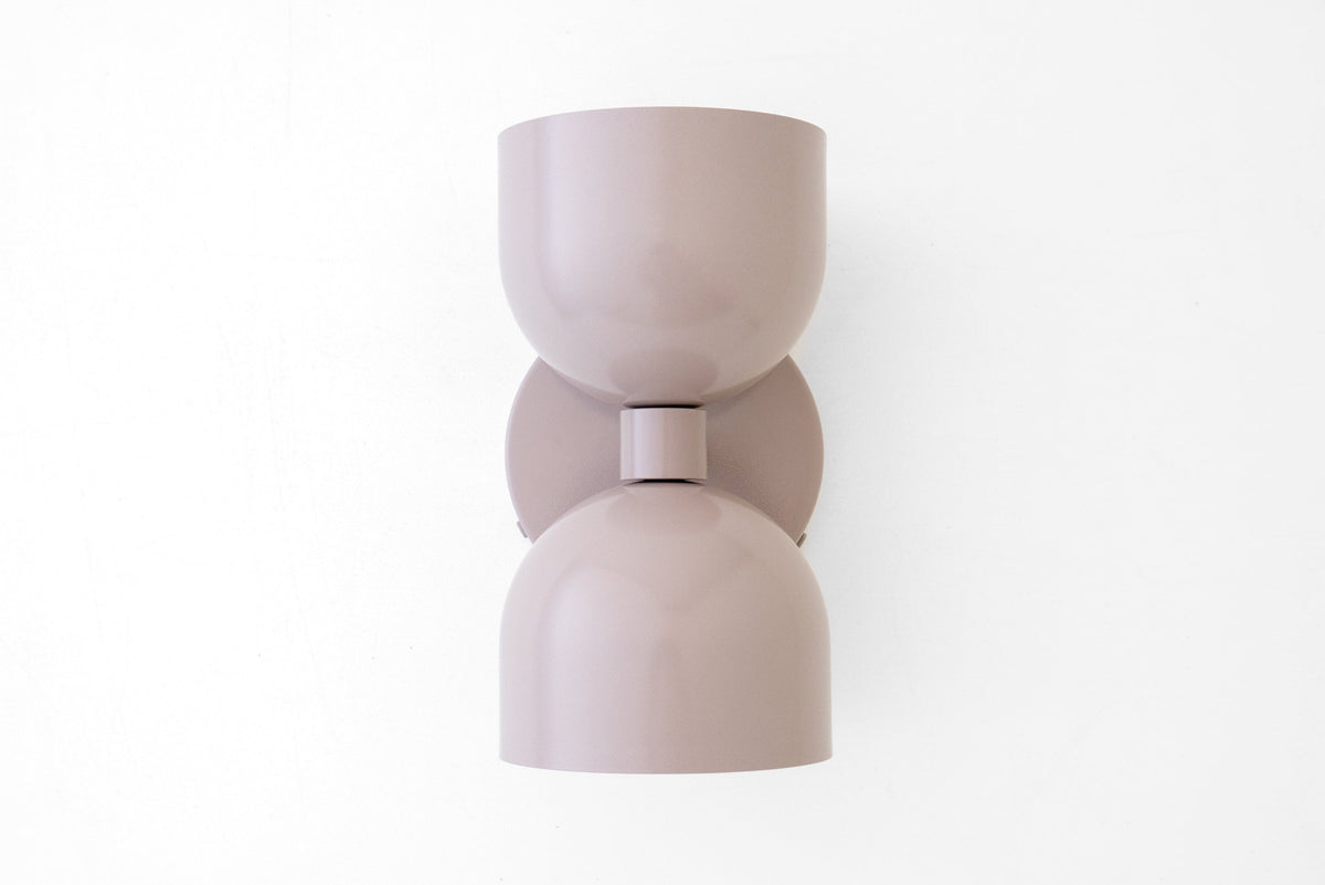 Matte mauve mid-century modern up/down wall sconce with rounded shade and backplate. - SCONCE MODEL NO. 5641