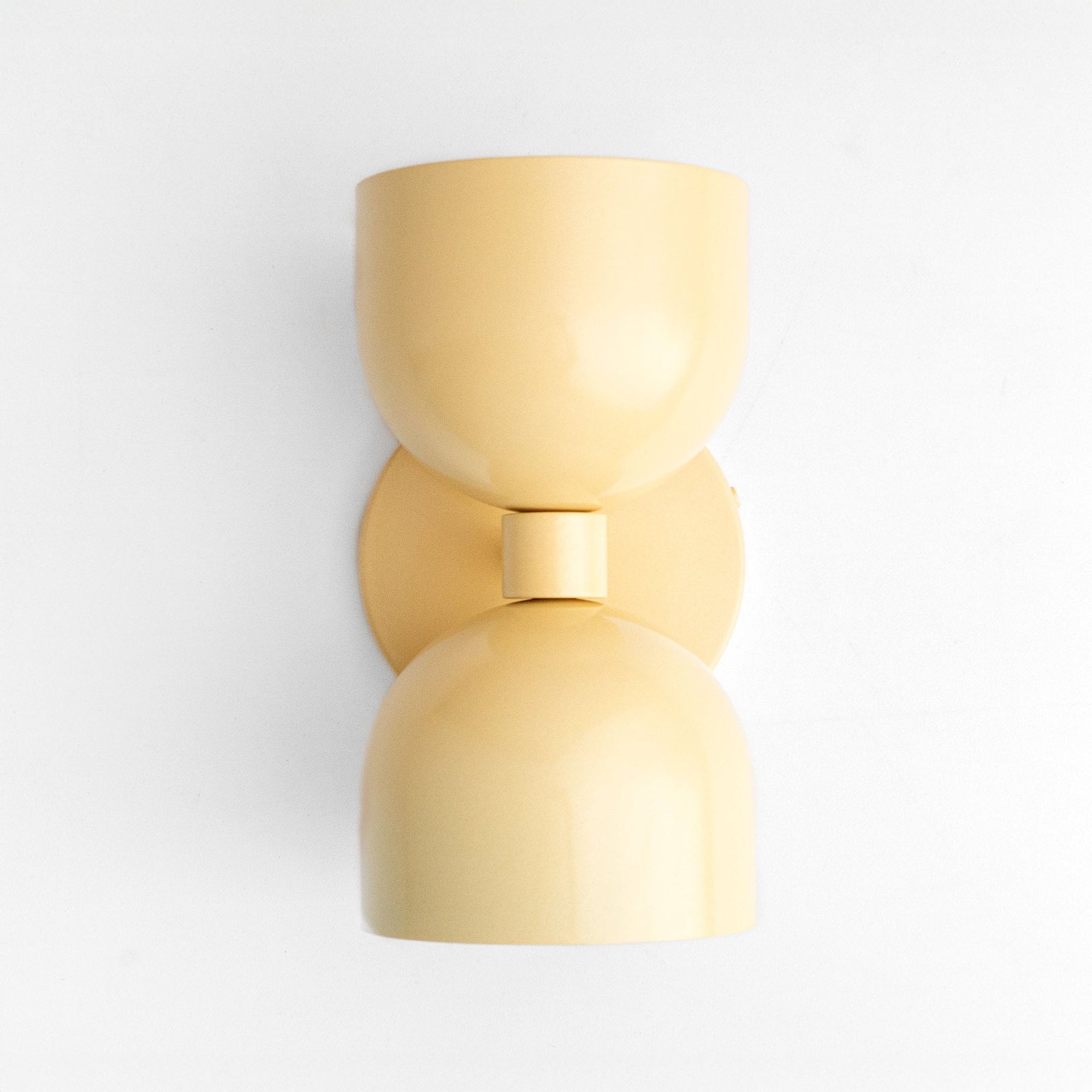 Mid-century modern yellow up/down wall sconce with smooth curved shade and matte finish. - SCONCE MODEL NO. 5641