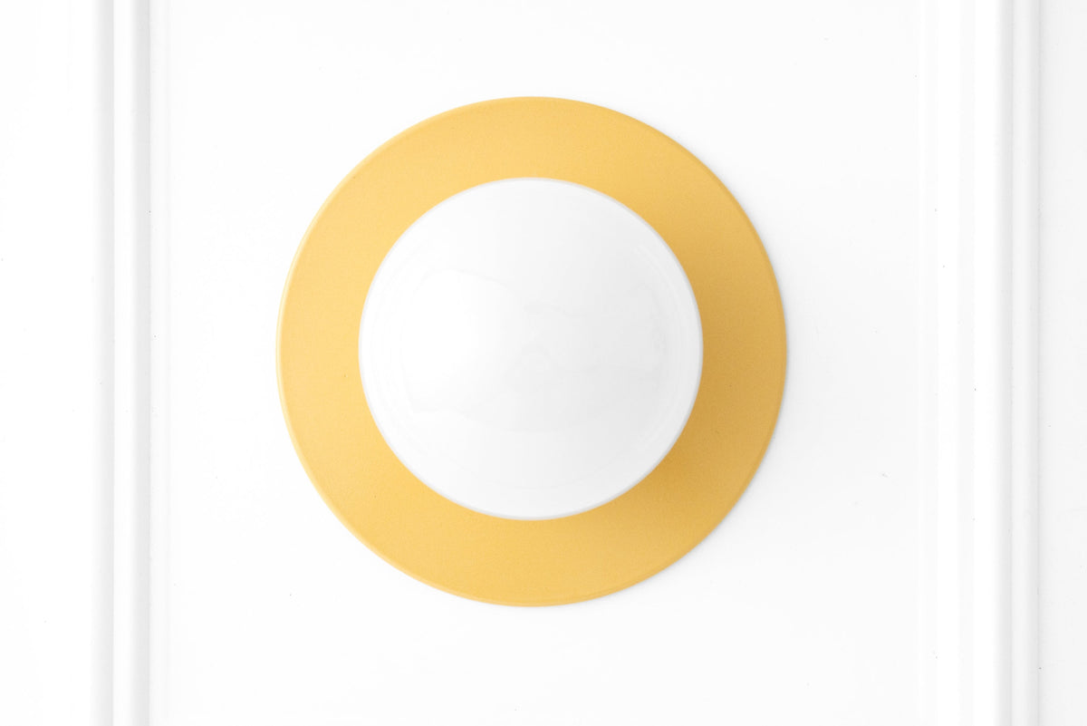 Yellow Scandinavian flush mount wall sconce with a white globe light and circular design. - SCONCE MODEL NO. 2277