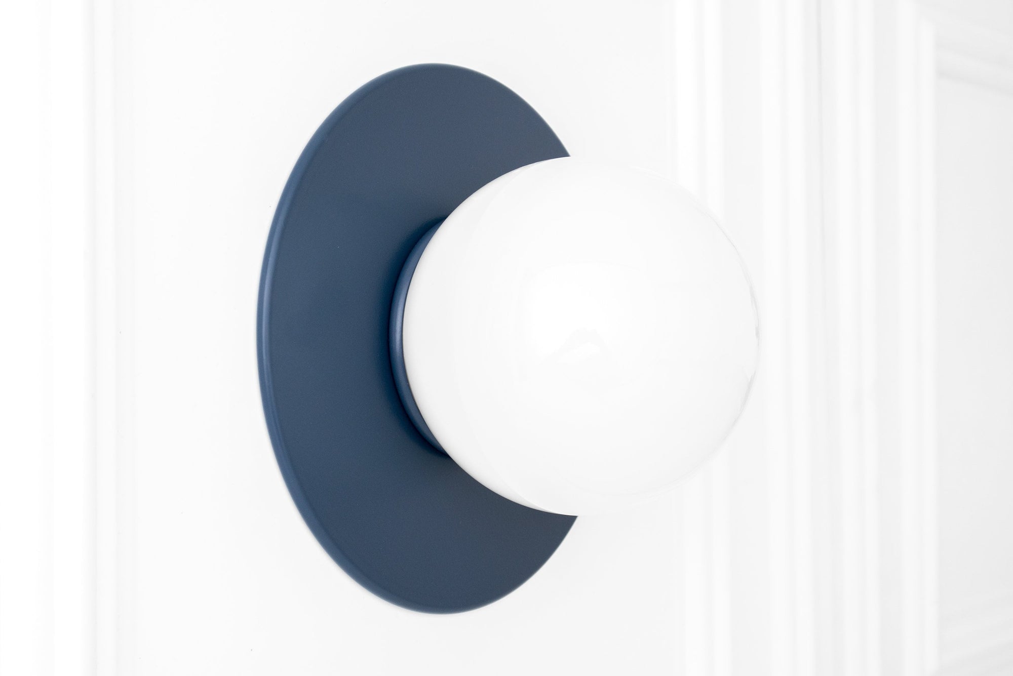 Scandinavian-style wall sconce with coal blue circular base and white frosted globe light. - SCONCE MODEL NO. 2277