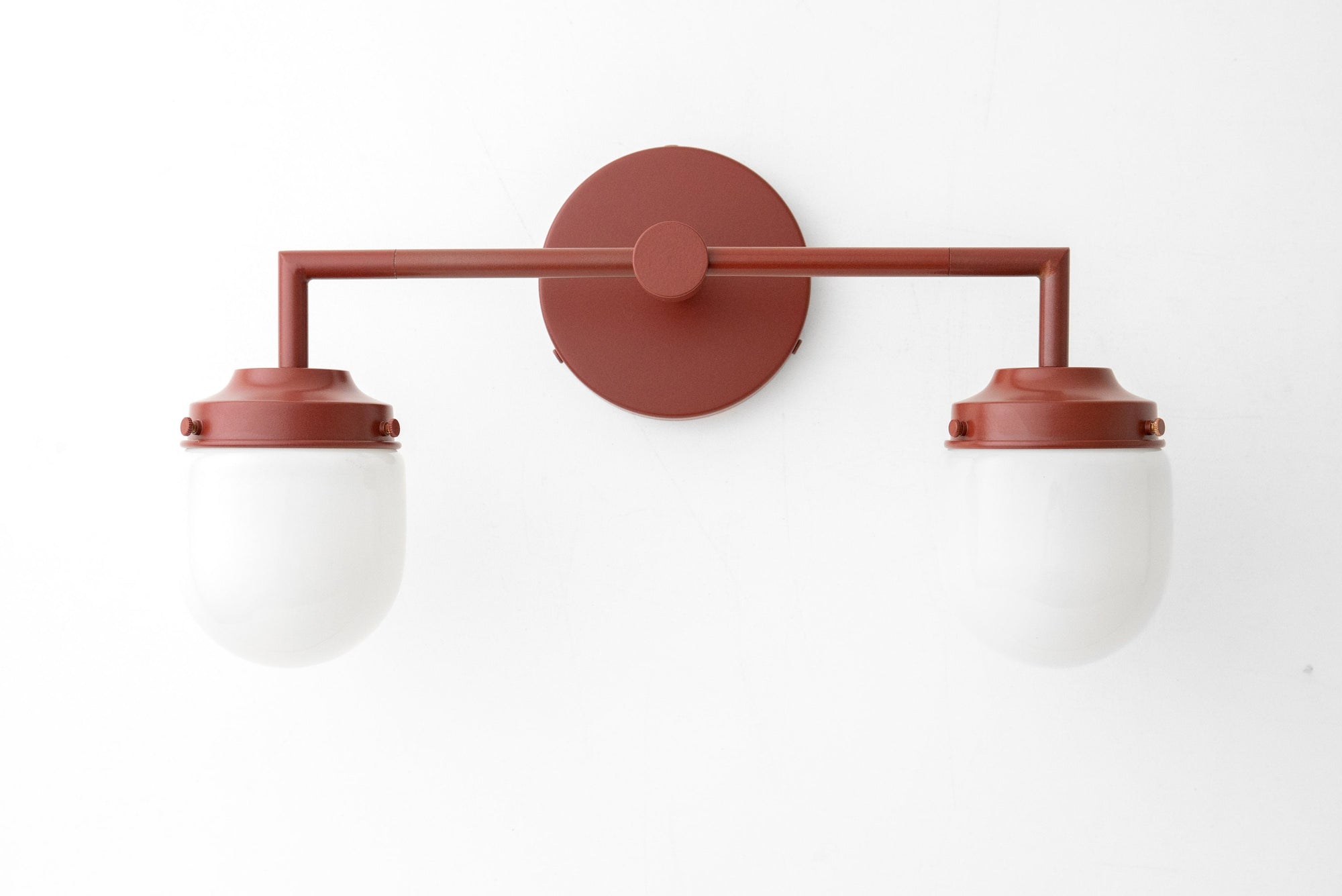Art Deco style 2-bulb vanity light with brick red metal frame and white globe shades. - VANITY LIGHT MODEL NO. 7536