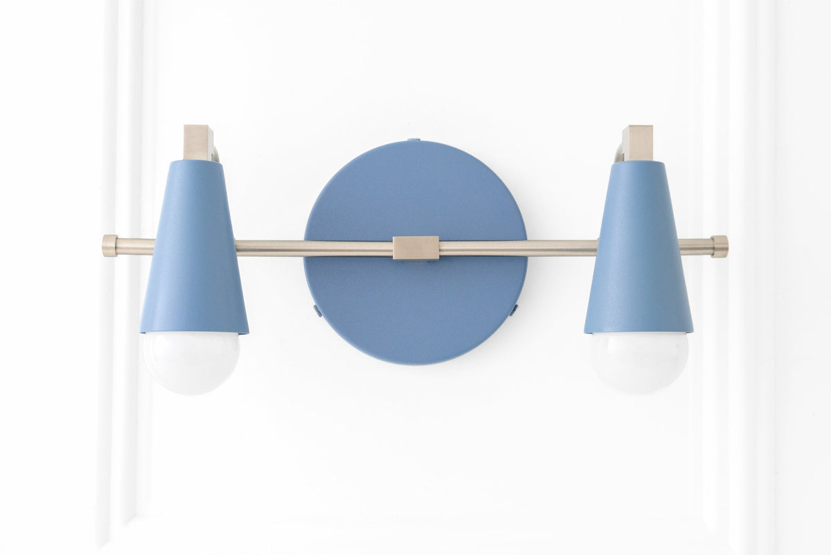 Scandinavian-style vanity light with two bare bulbs, powder blue conical shades, and brushed nickel finish. - VANITY LIGHT MODEL NO. 1229