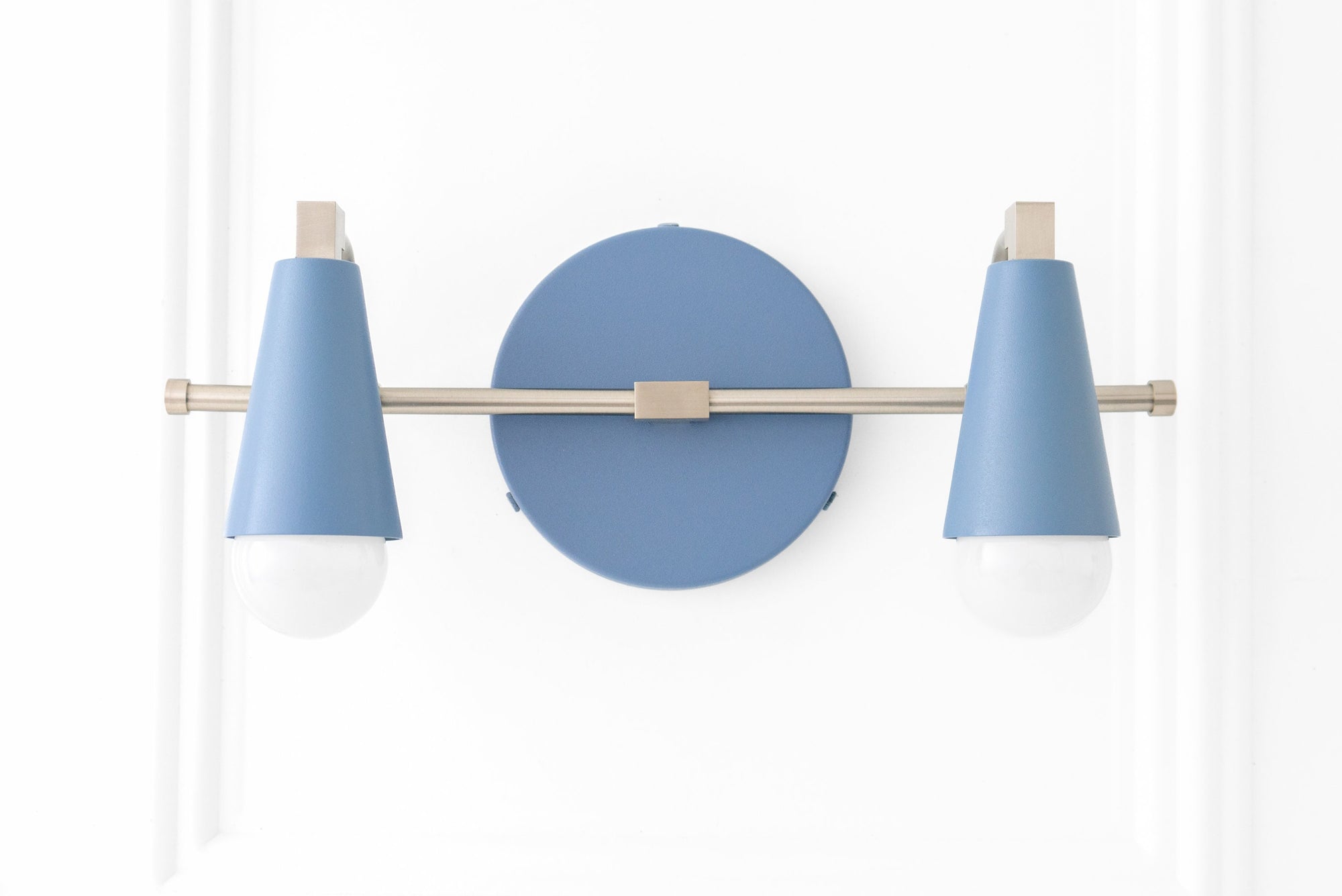 Scandinavian-style vanity light with two bare bulbs, powder blue conical shades, and brushed nickel finish. - VANITY LIGHT MODEL NO. 1229