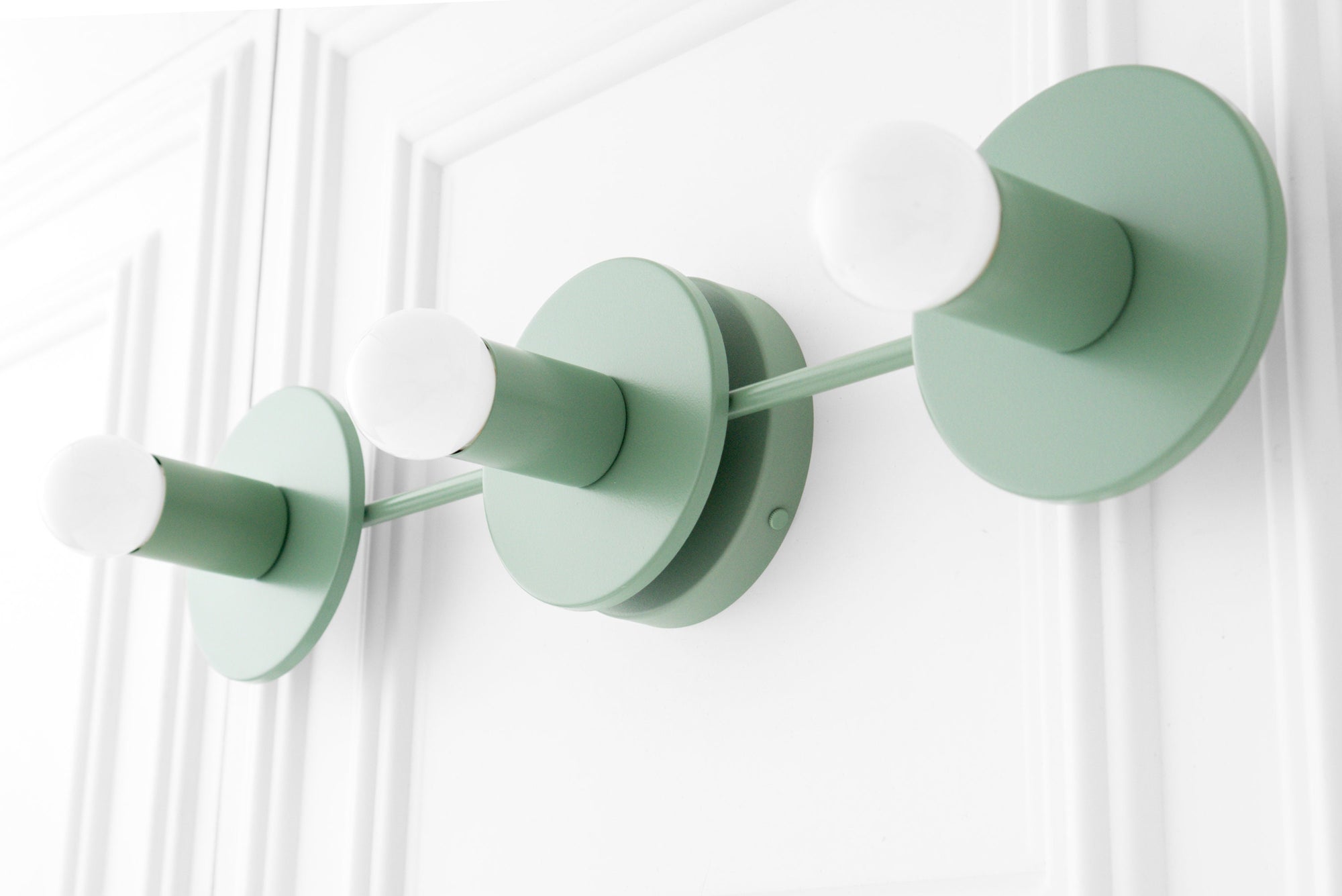 Green mid-century modern three-bulb vanity light with exposed round white bulbs and circular wall mounts. - VANITY LIGHT MODEL NO. 5708