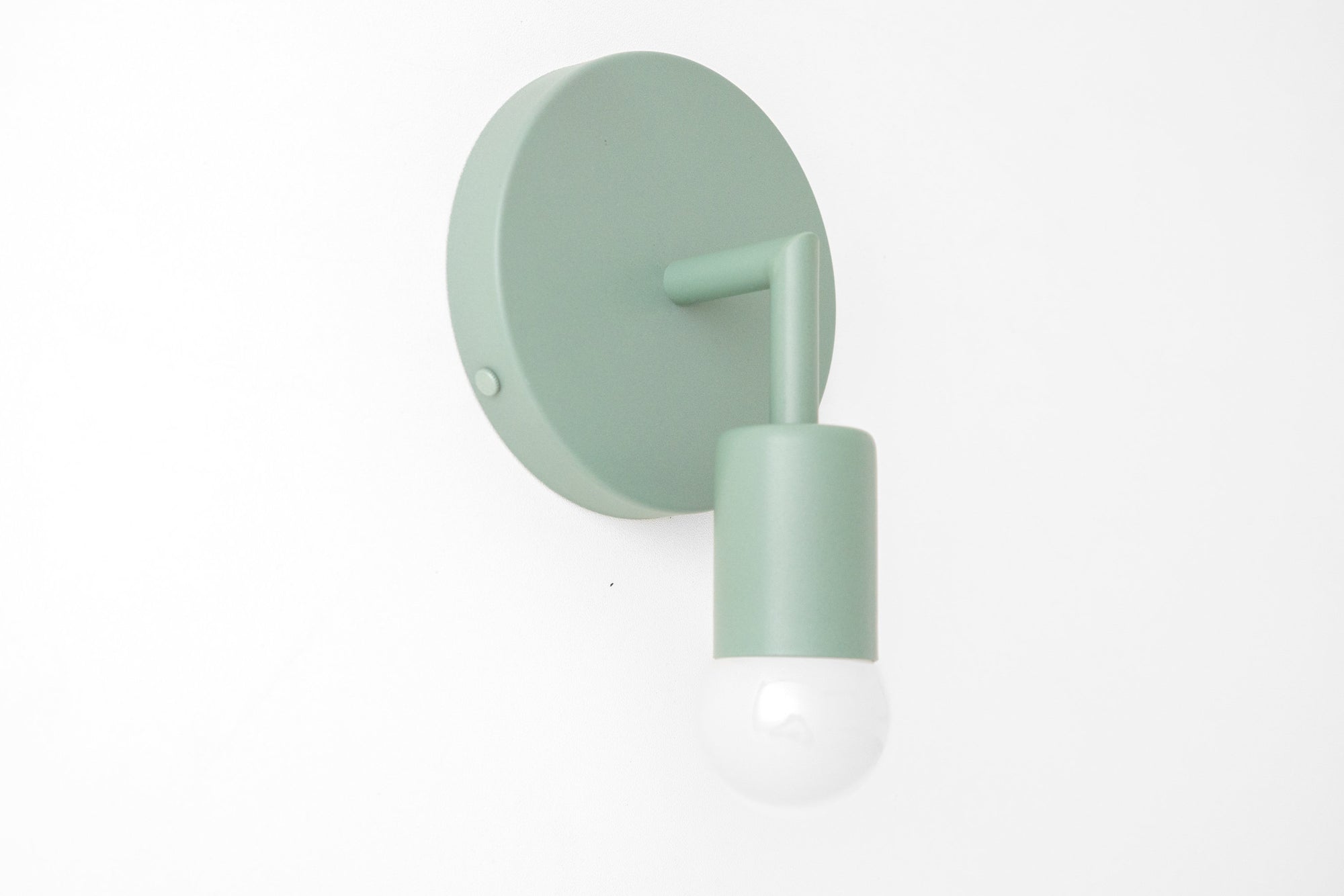 Matte green Scandinavian bare bulb wall sconce with round backplate and cylindrical shade. - SCONCE MODEL NO. 5480