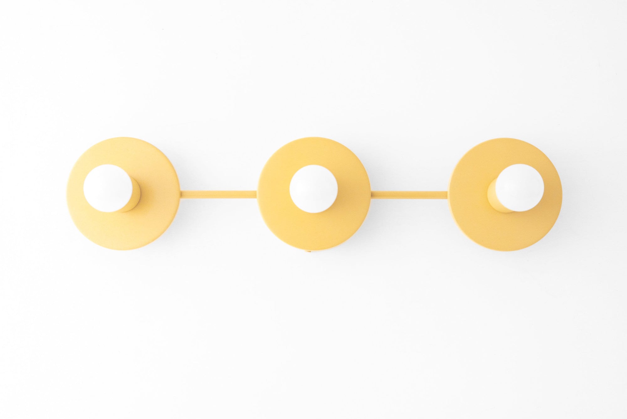 Yellow three-bulb vanity light with round shades and minimalist Scandinavian design. - VANITY LIGHT MODEL NO. 5708
