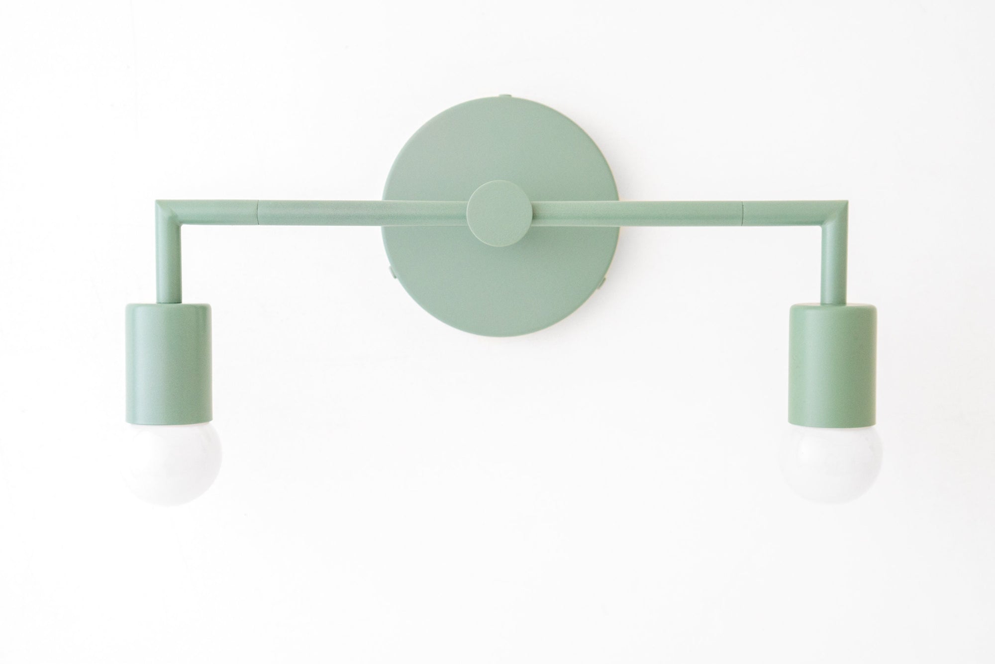 Matte green two-bulb vanity light with minimalist cylindrical shades and round wall mount. - VANITY LIGHT MODEL NO. 1561