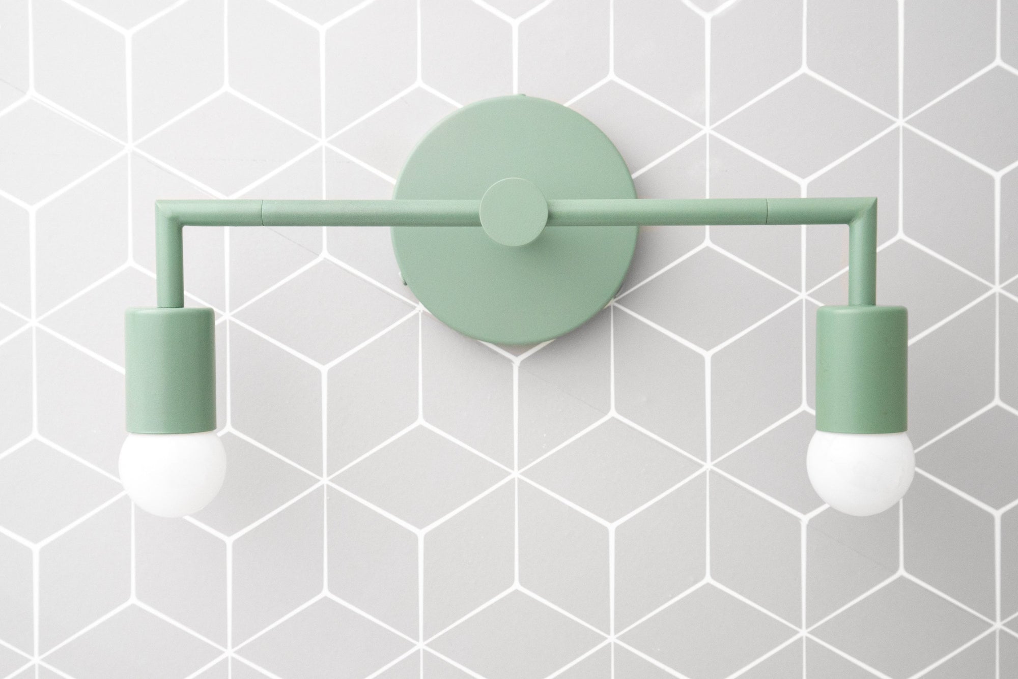 Mid-century modern two-bulb vanity light in soft matte green with round backplate. - VANITY LIGHT MODEL NO. 1561