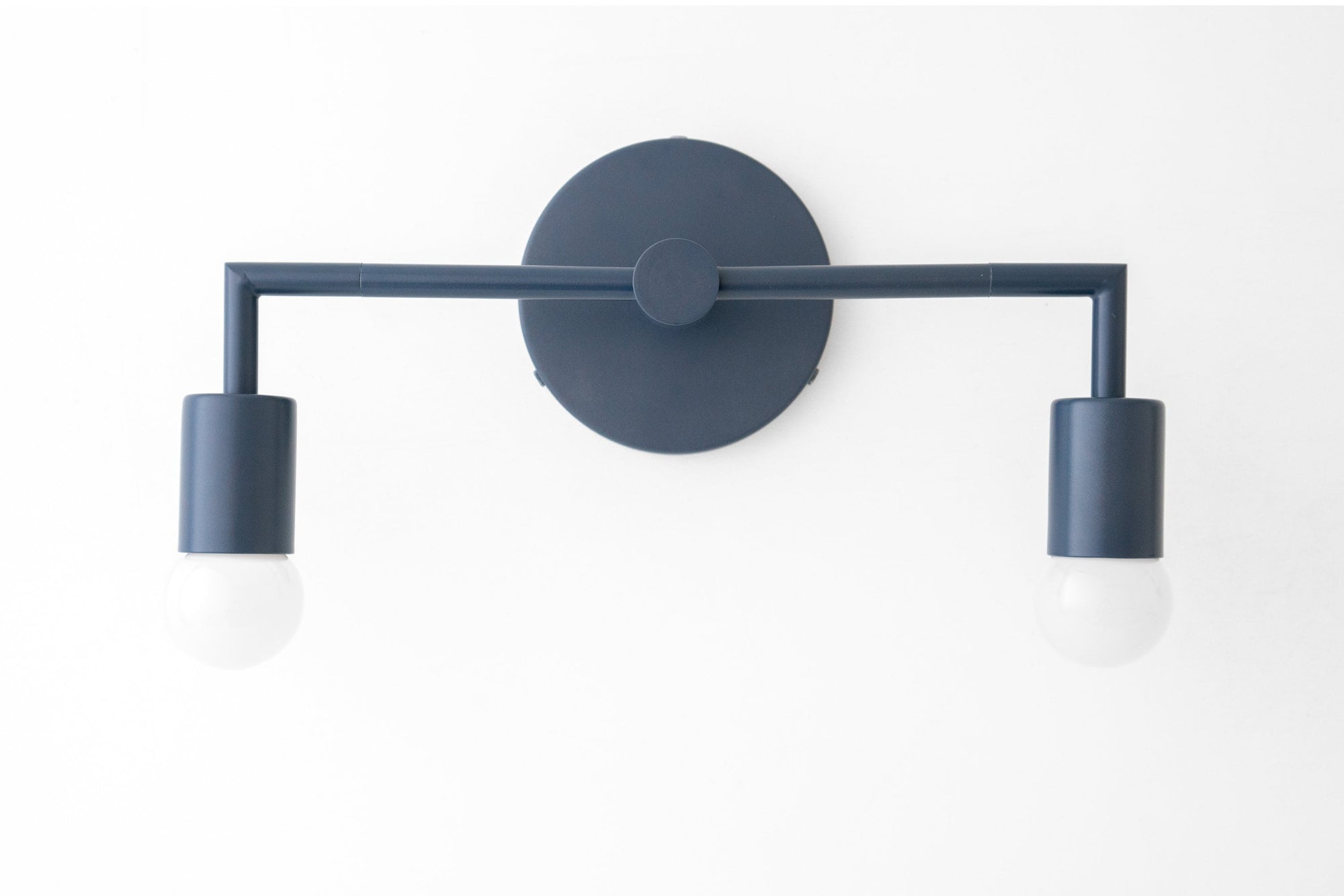 Matte black two-bulb vanity light with cylindrical shades and round wall mount. - VANITY LIGHT MODEL NO. 1561