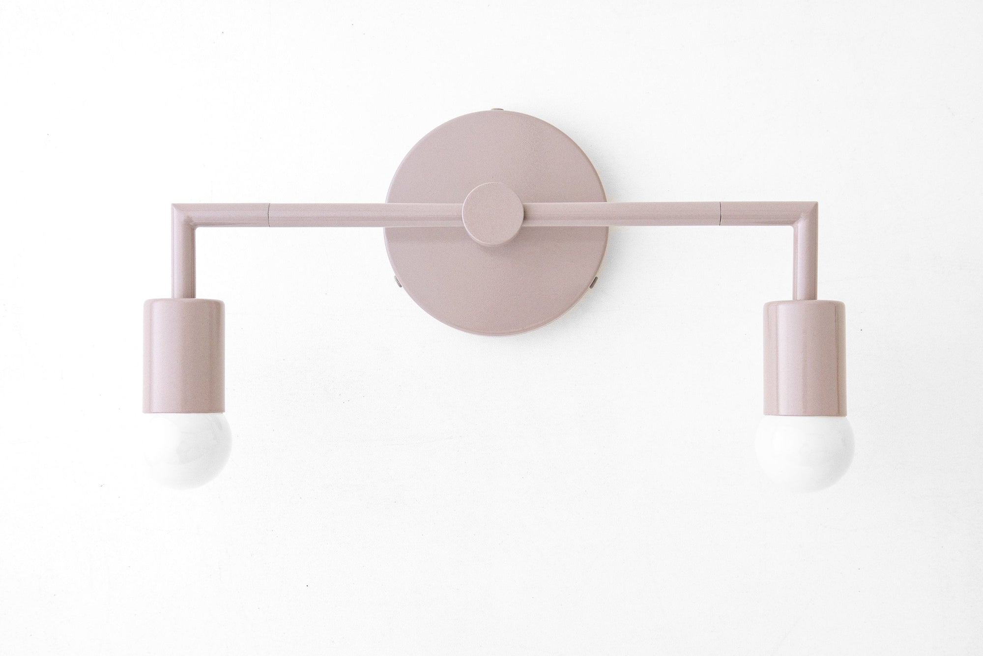 Mid-century modern mauve vanity light with two exposed bulbs and round wall mount. - VANITY LIGHT MODEL NO. 1561