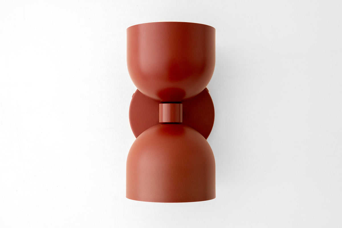 Mid-century modern brick red up/down metal wall sconce with smooth curved shade. - SCONCE MODEL NO. 5641