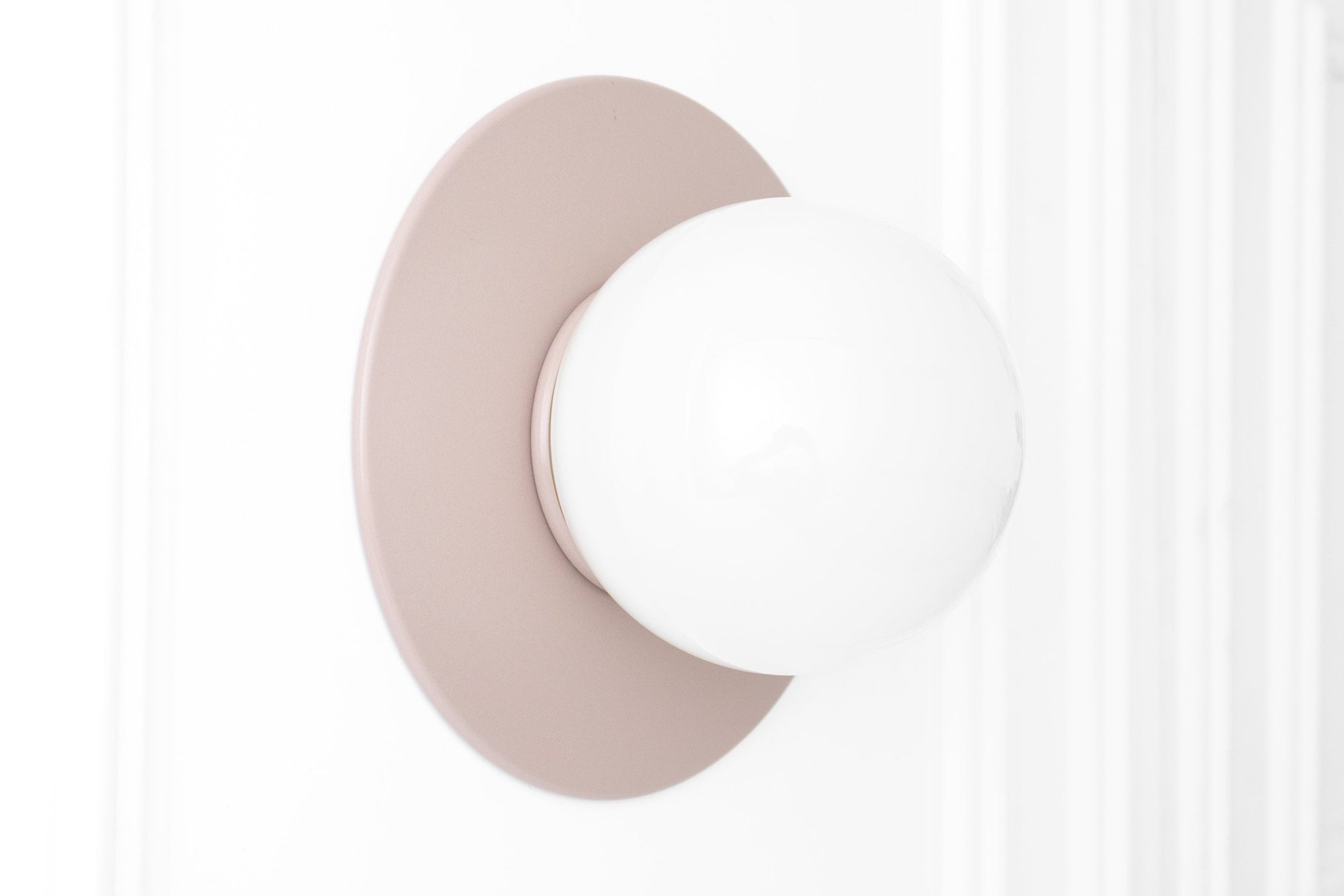 Scandinavian-style wall sconce with a mauve flush mount and white globe light. - SCONCE MODEL NO. 2277
