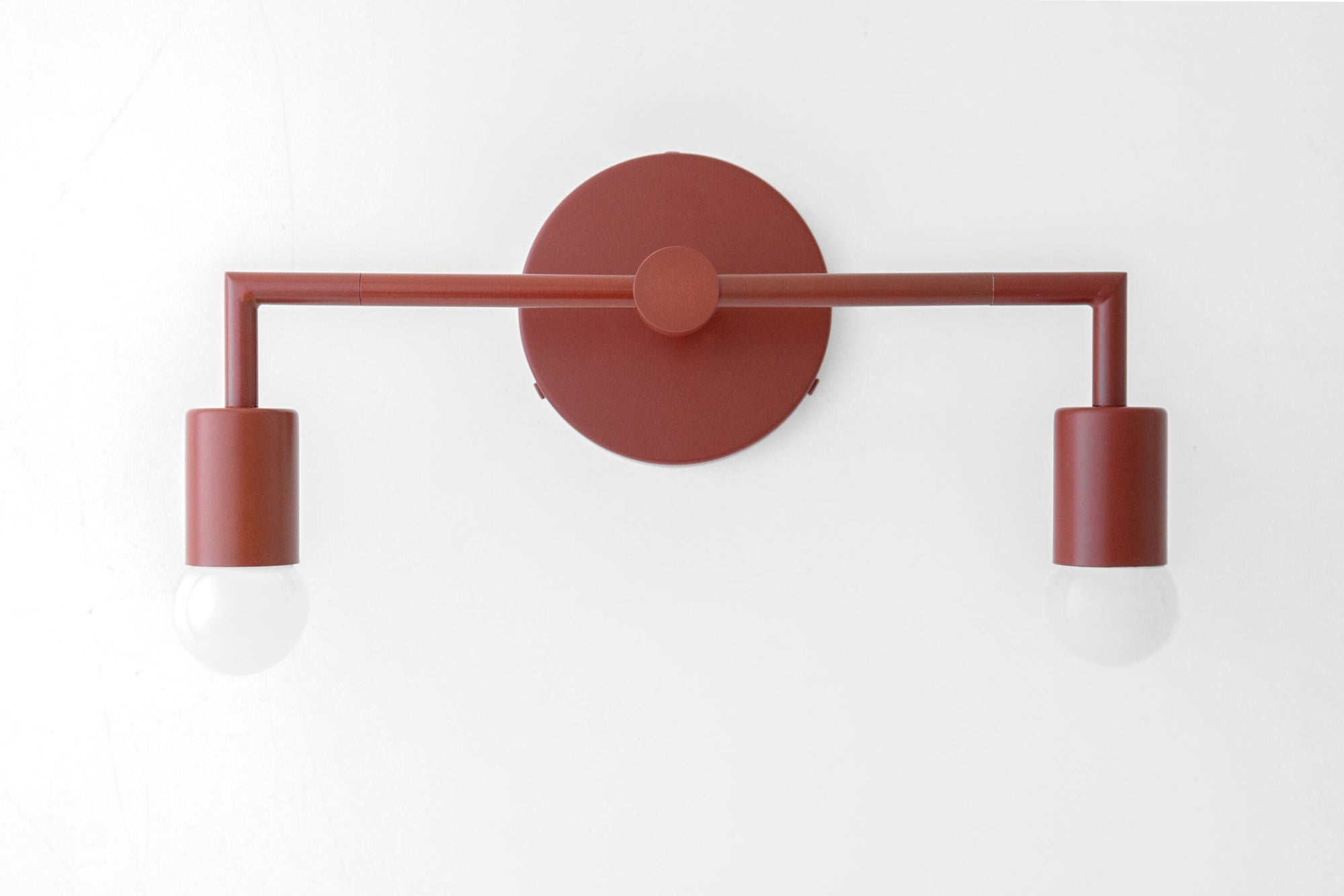 Brick red two-bulb vanity light with matte finish and exposed round bulbs. - VANITY LIGHT MODEL NO. 1561