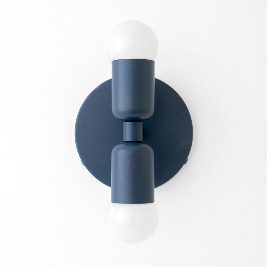 Mid-century modern coal blue metal sconce with up/down exposed white bulbs and circular backplate. - SCONCE MODEL NO. 2660