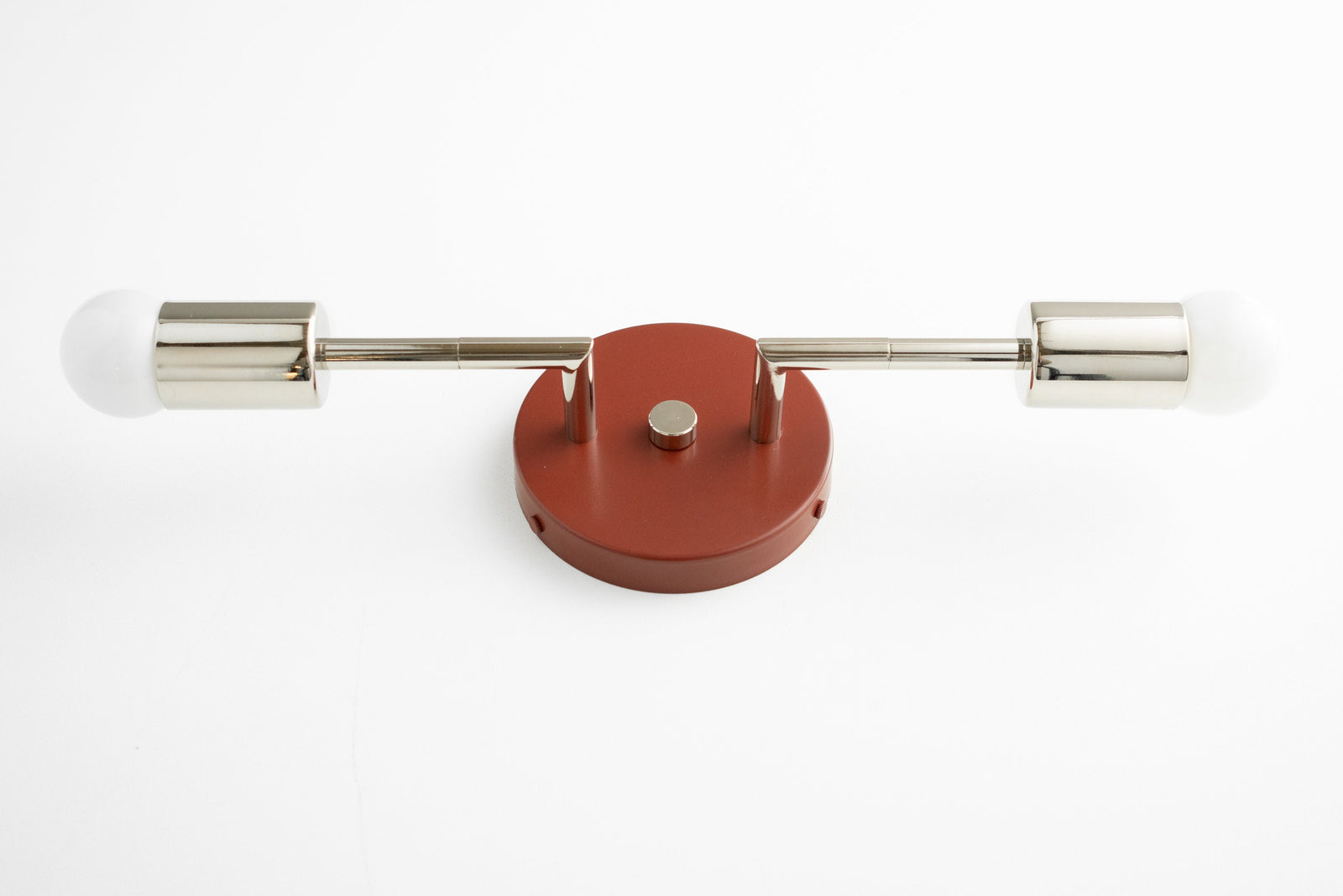 Mid-century modern vanity light with two bare bulbs, brushed nickel arms, and brick red base. - VANITY LIGHT MODEL NO. 1938