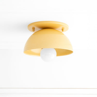 Yellow Scandinavian-style flush mount ceiling light with dome shade and exposed bulb. - CEILING LIGHT MODEL NO. 4812