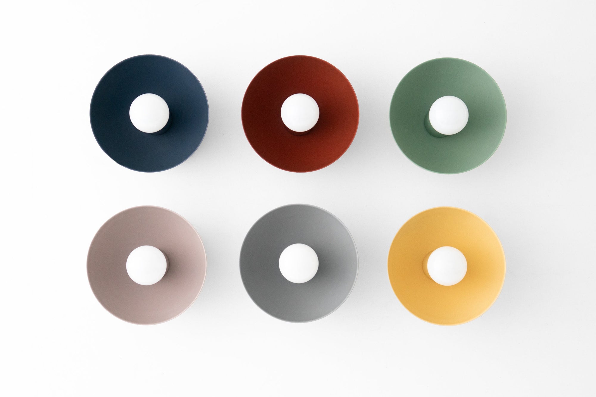 Six round metal sconce shades in coal blue, brick red, green, mauve, gray, and yellow arranged in two rows on a white. - SCONCE MODEL NO. 4812