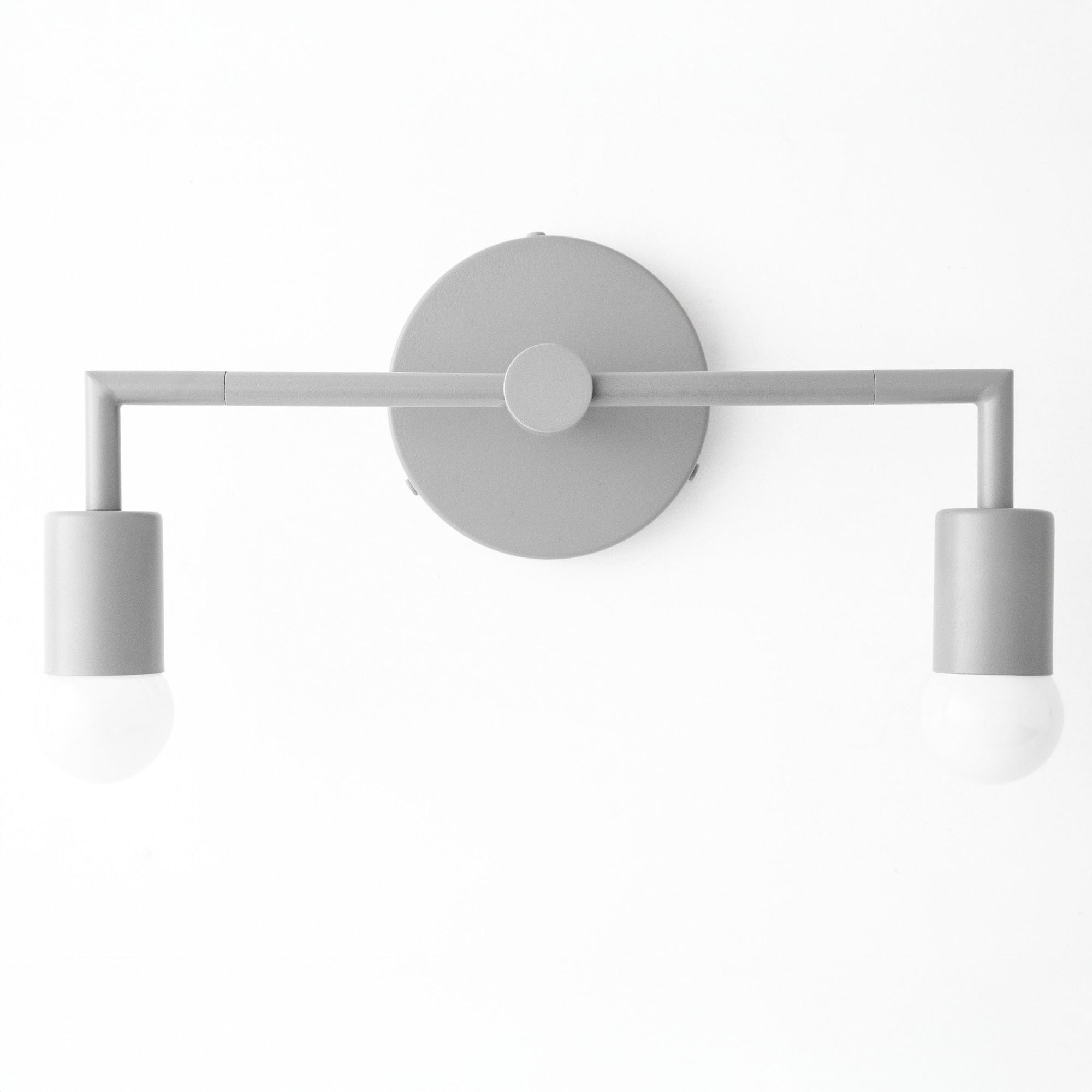 Matte gray two-bulb vanity light with cylindrical shades and round wall mount. - VANITY LIGHT MODEL NO. 1561