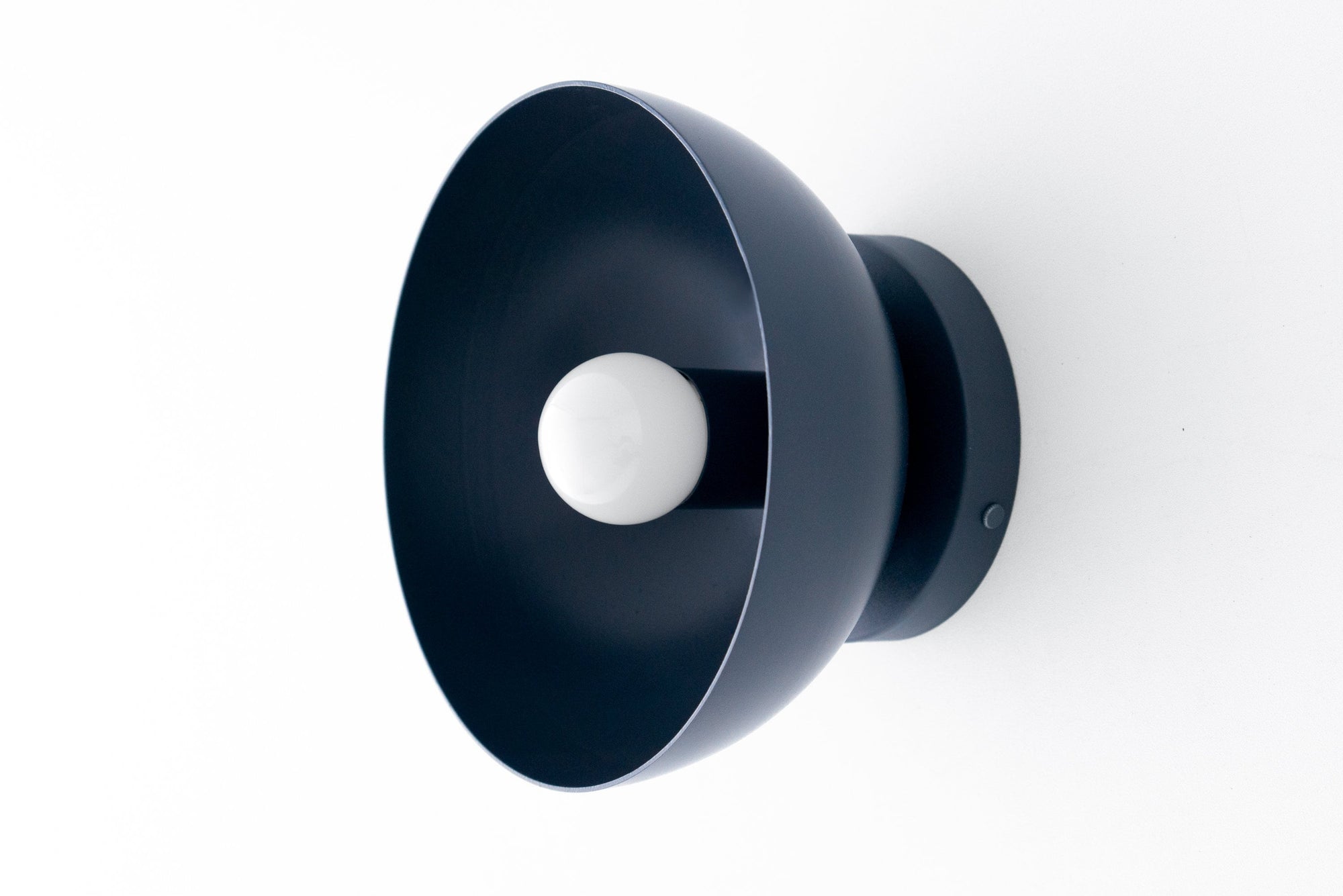 Black Scandinavian bare bulb wall sconce with wide dome-shaped metal shade and round base. - SCONCE MODEL NO. 9105