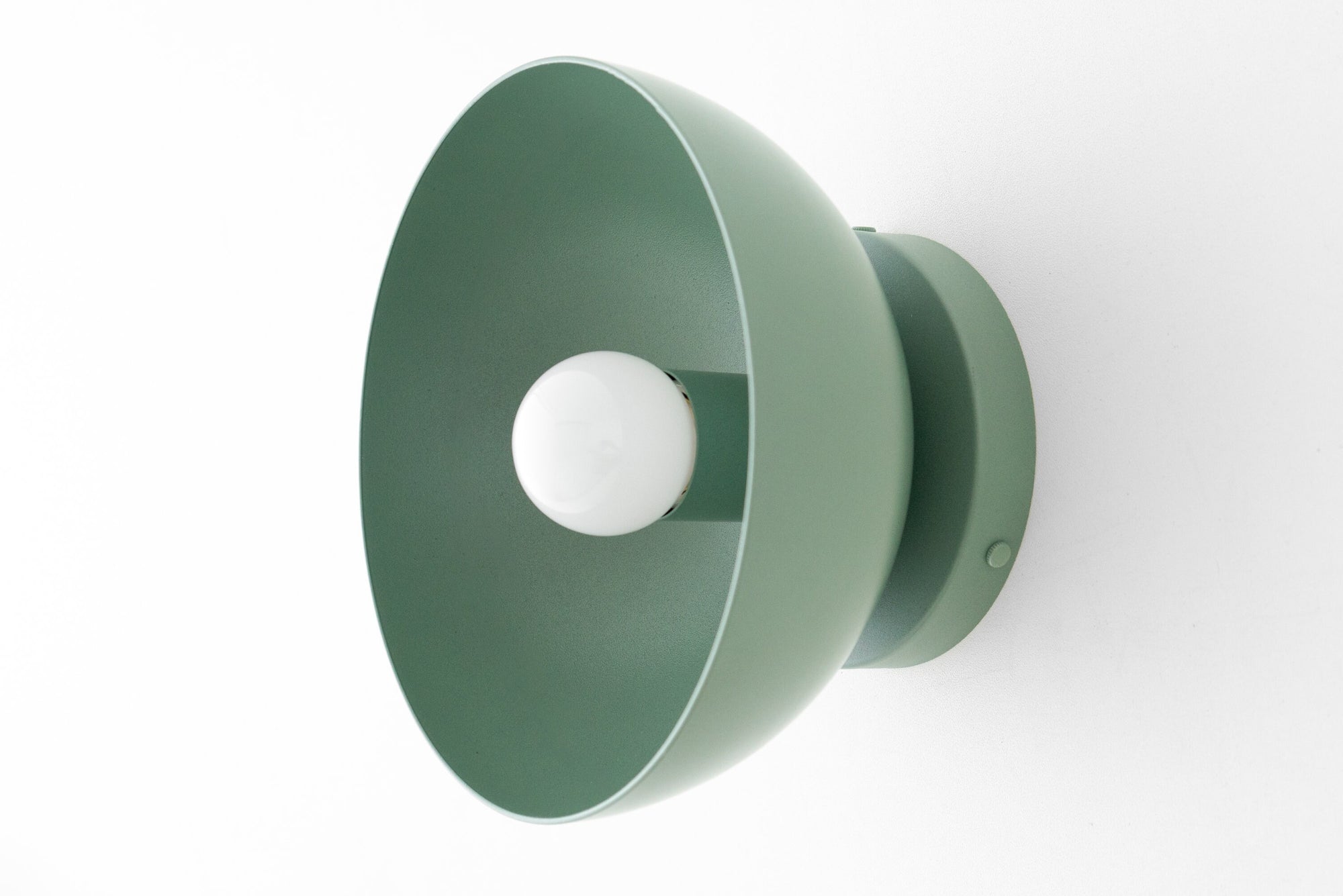 Mauve dome-shaped Scandinavian flush sconce with exposed white bulb and sleek metal base. - SCONCE MODEL NO. 9105