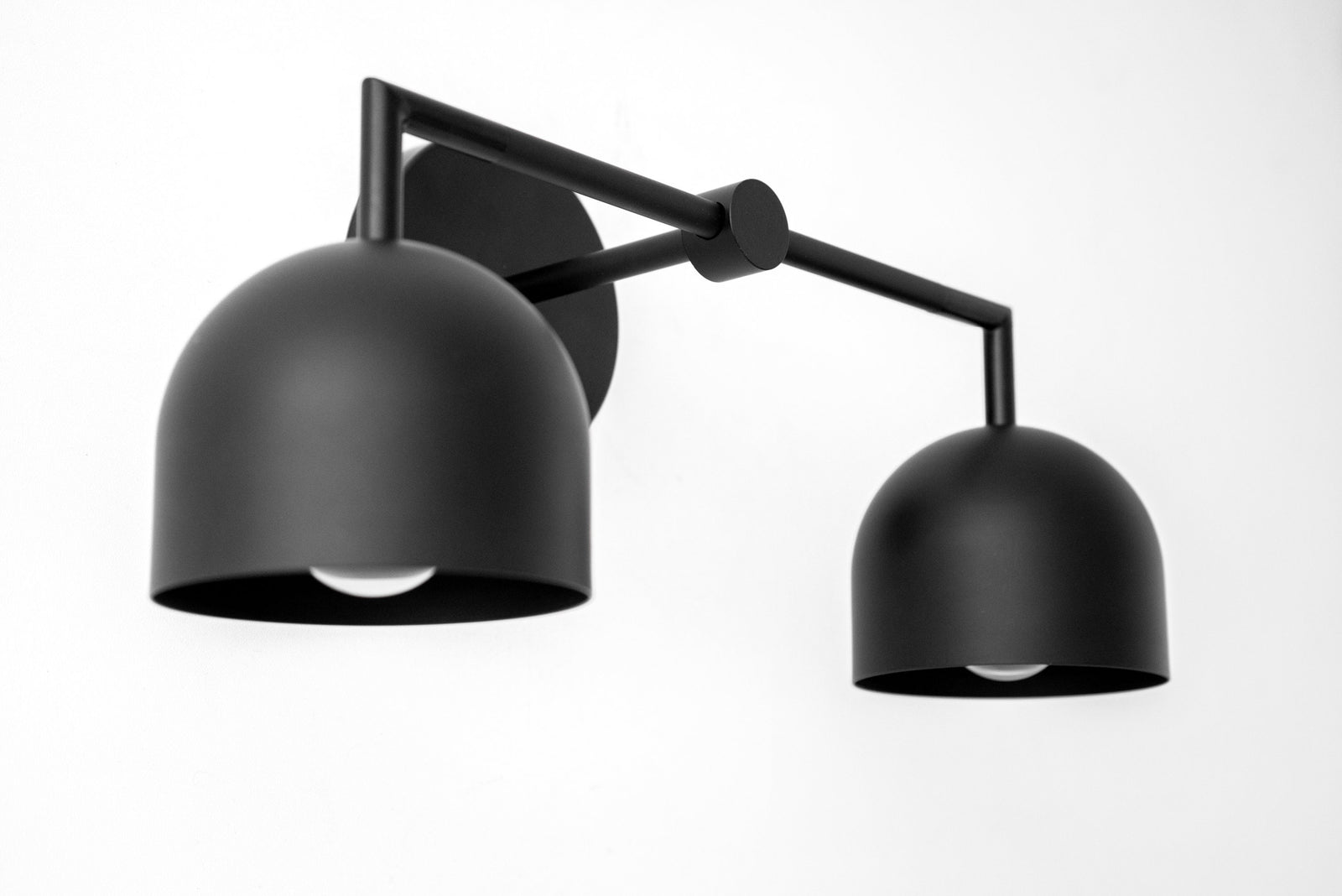 Black matte metal 2-bulb vanity light with dome-shaped shades and adjustable arms. - VANITY LIGHT MODEL NO. 8432