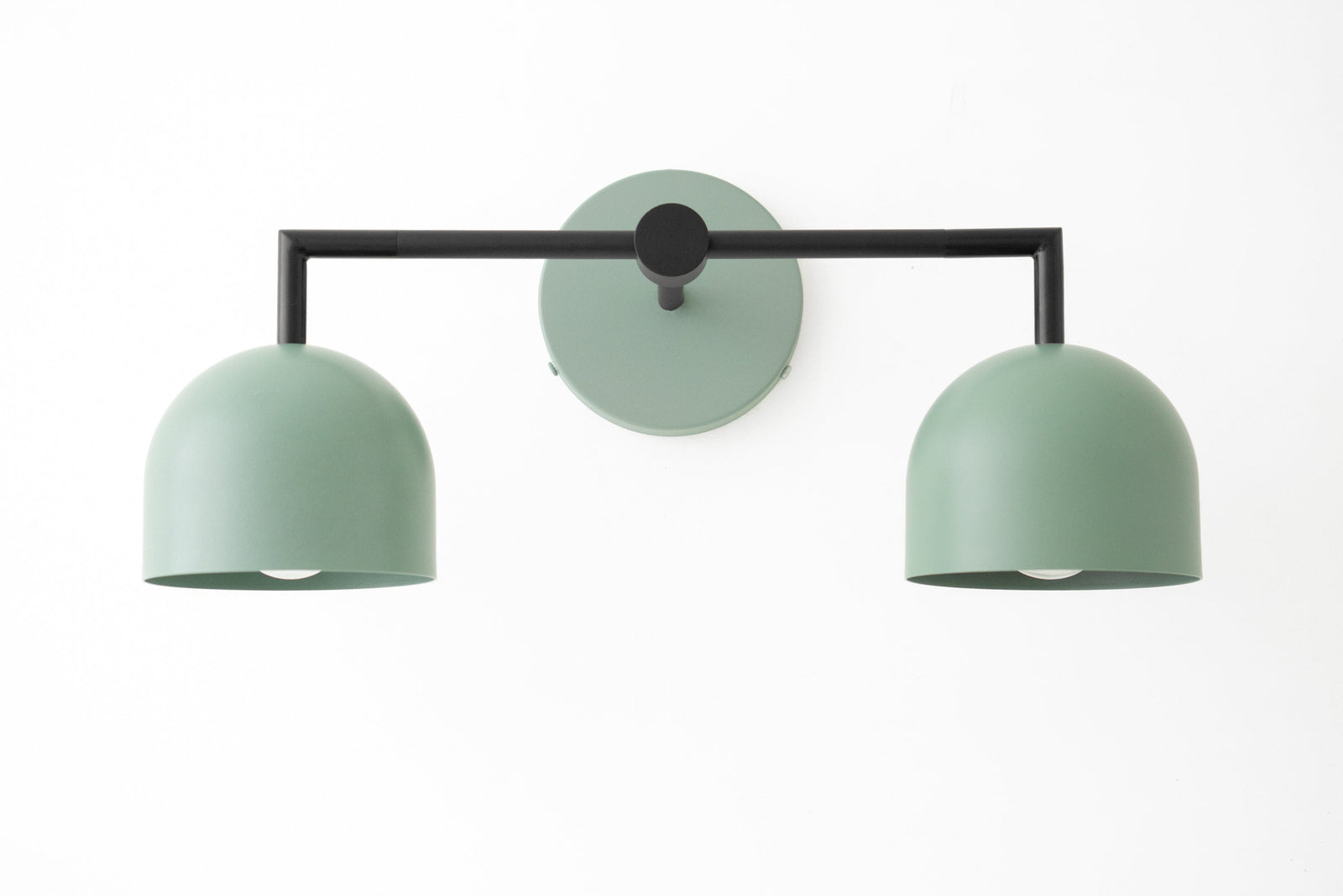 Matte green dual shade vanity light with black frame and round wall mount in modern Art Deco style. - VANITY LIGHT MODEL NO. 8432