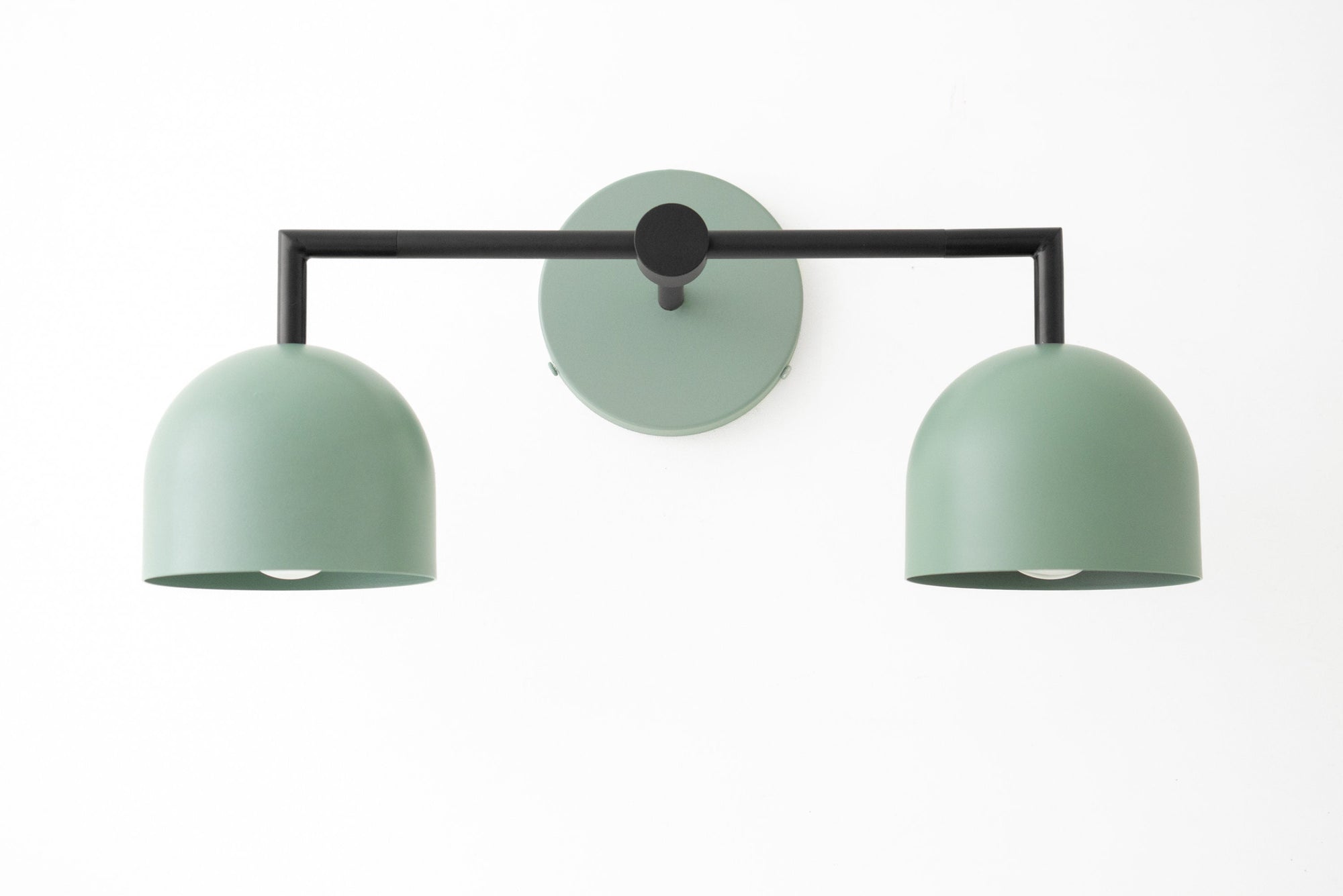 Matte green dual shade vanity light with black frame and round wall mount in modern Art Deco style. - VANITY LIGHT MODEL NO. 8432