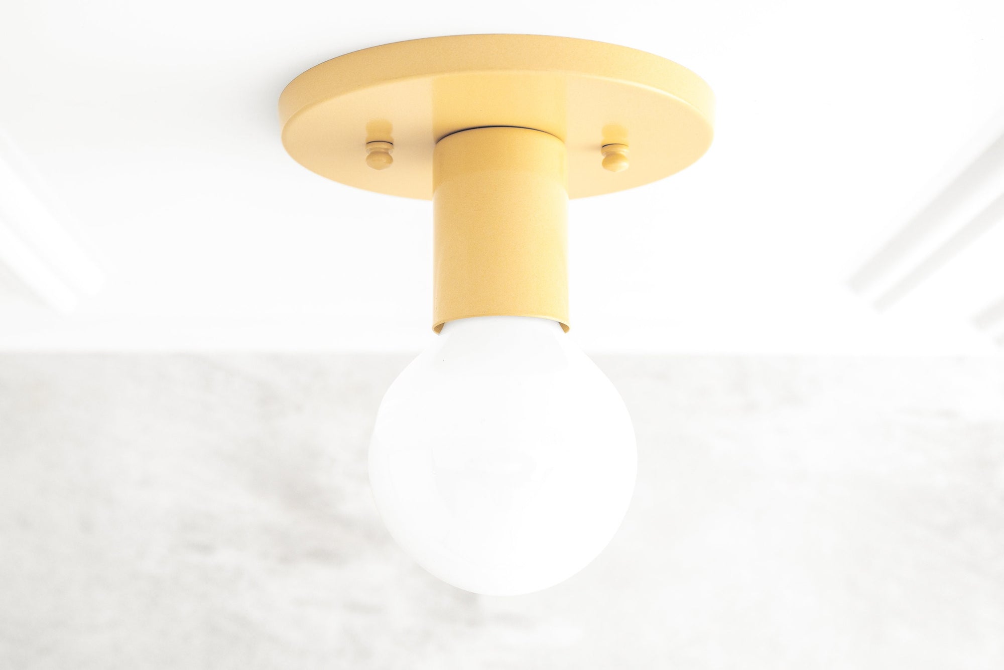 Flush-mount yellow metal sconce with exposed round white bulb and minimalist design. - SCONCE MODEL NO. 4460