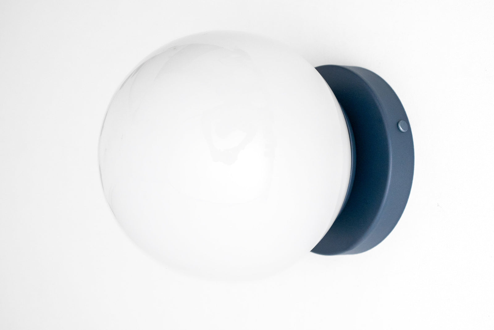 Mid-century modern black flush mount sconce with white glass globe shade. - SCONCE MODEL NO. 3825