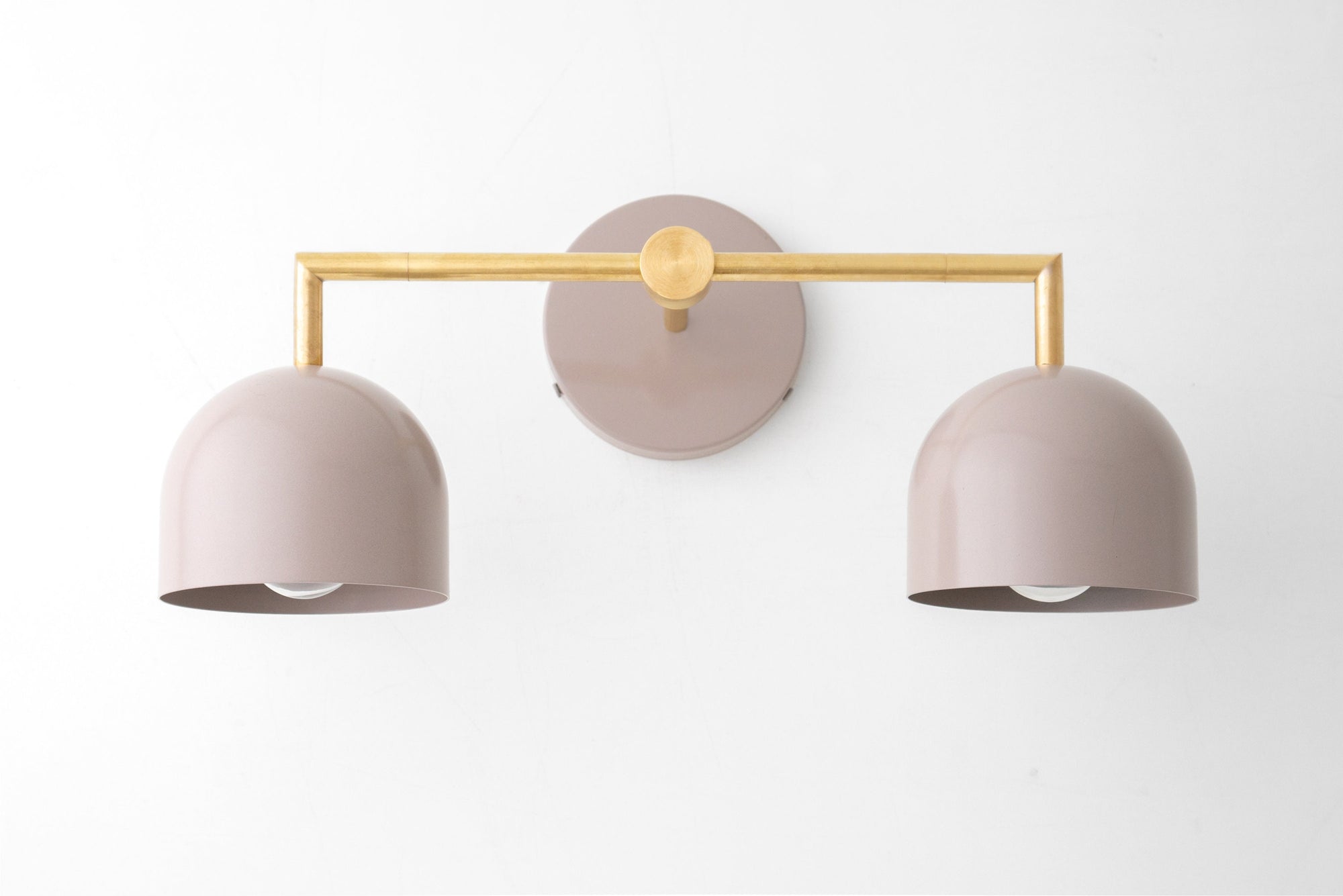 Raw brass vanity light with dual mauve matte dome shades and minimalist horizontal bar design. - VANITY LIGHT MODEL NO. 8432