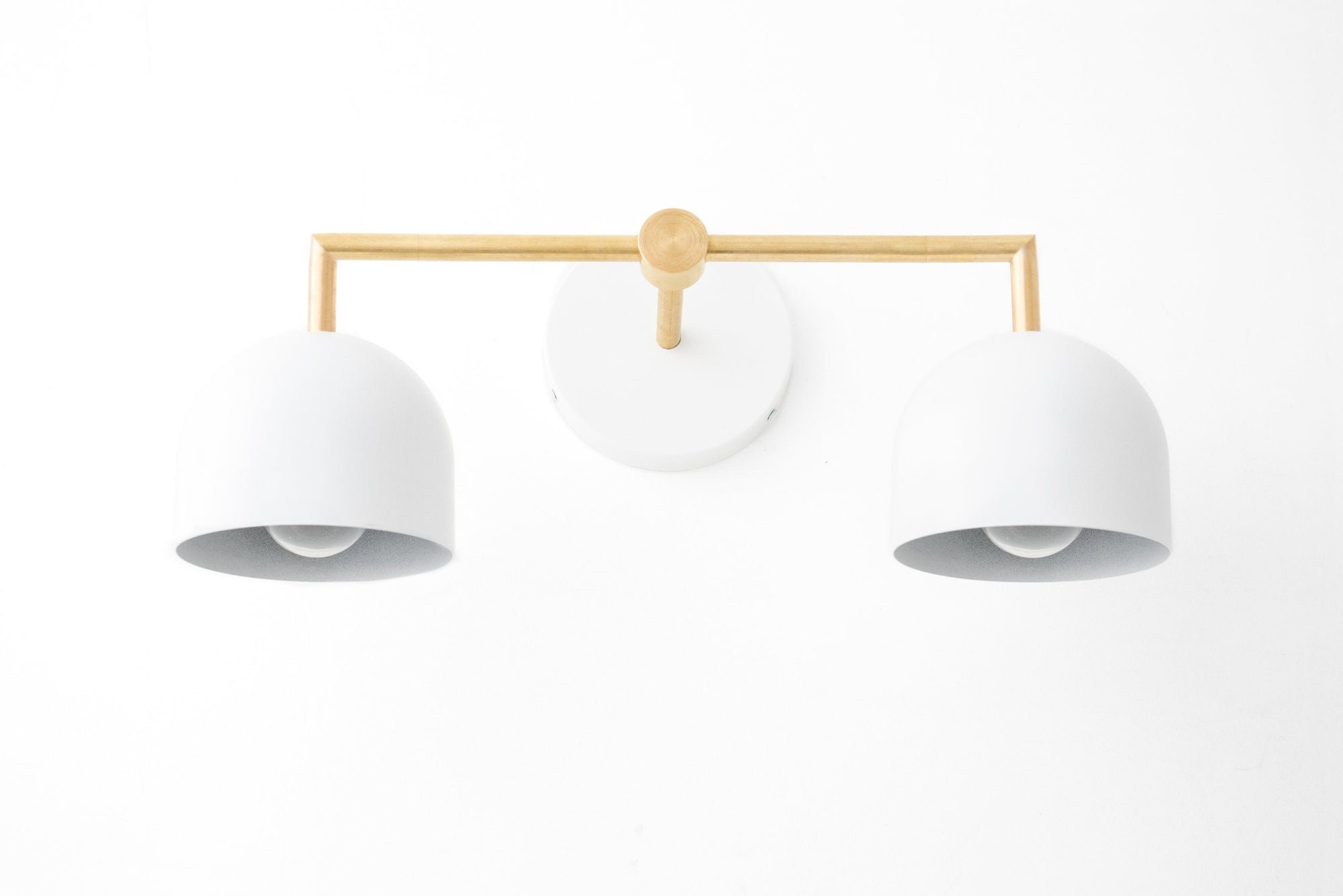 Raw brass two-bulb vanity light with white dome shades and round wall mount. - VANITY LIGHT MODEL NO. 8432