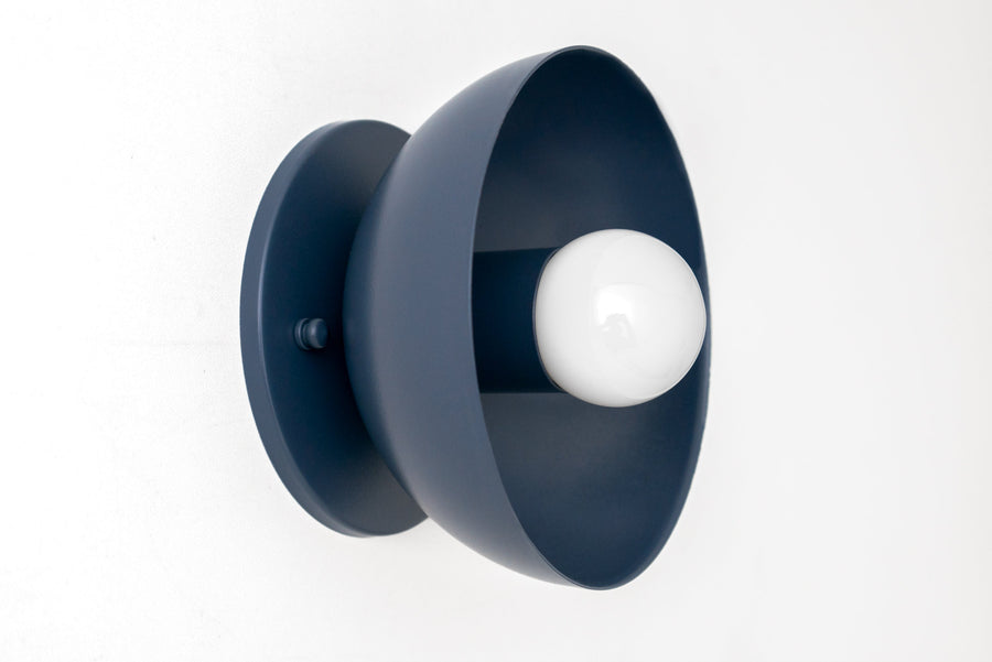 Matte coal blue metal wall sconce with a round flush base and exposed white bulb. - SCONCE MODEL NO. 4812