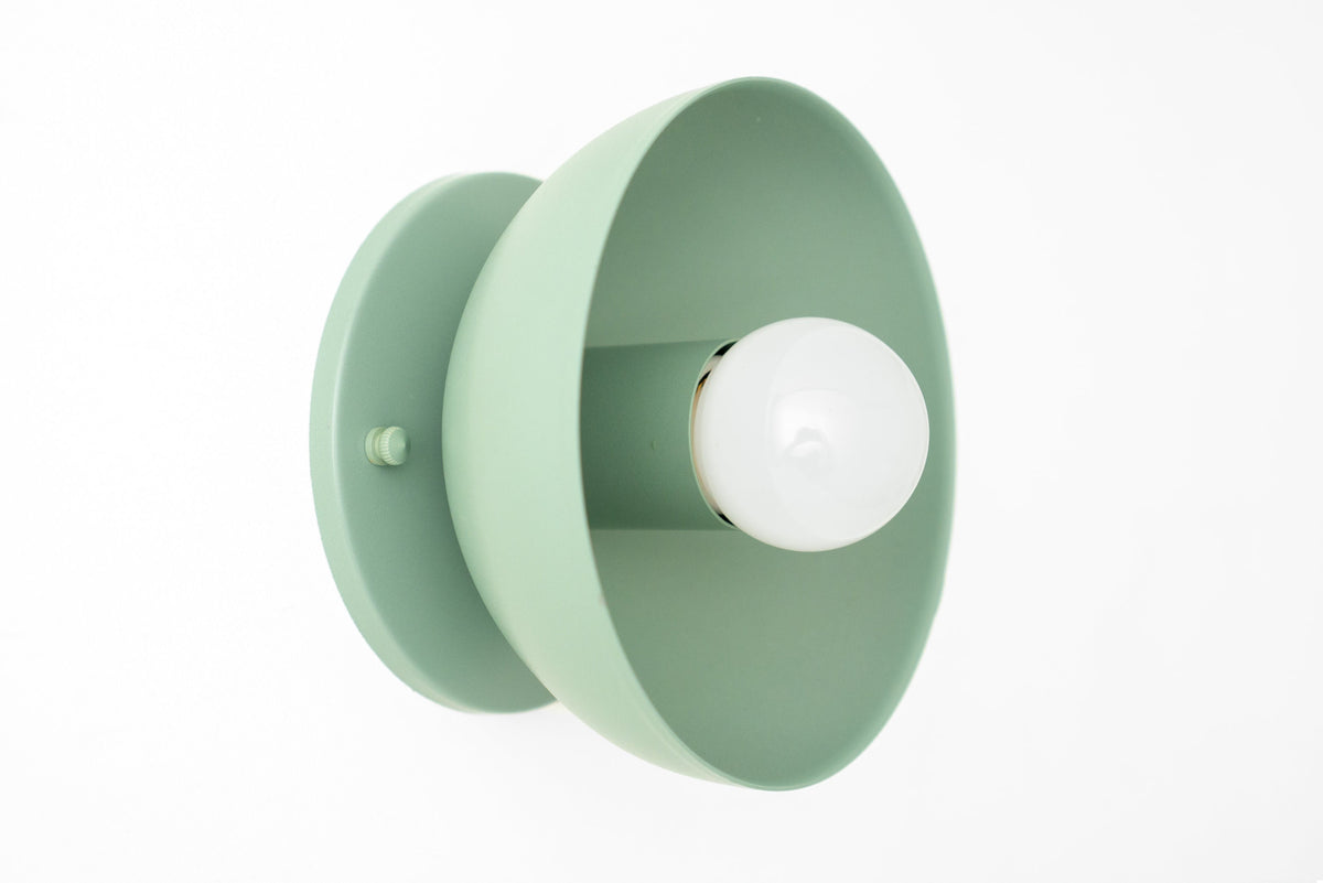 Matte pale green round metal wall sconce with exposed white bulb and flush mount base. - SCONCE MODEL NO. 4812