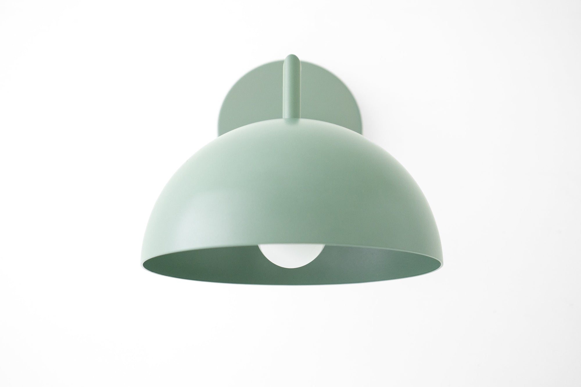 Matte sage green dome-shaped wall sconce with smooth finish and white interior shade. - SCONCE MODEL NO. 6952