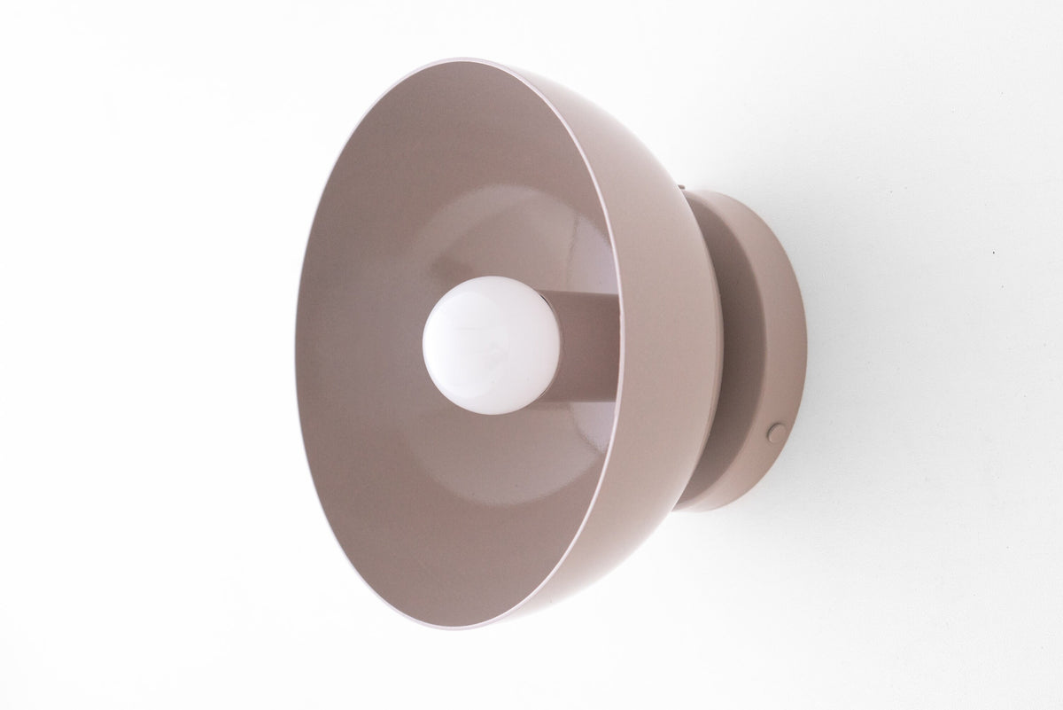 Flush Scandinavian-style wall sconce in mauve with a dome-shaped shade and exposed bulb. - SCONCE MODEL NO. 9105