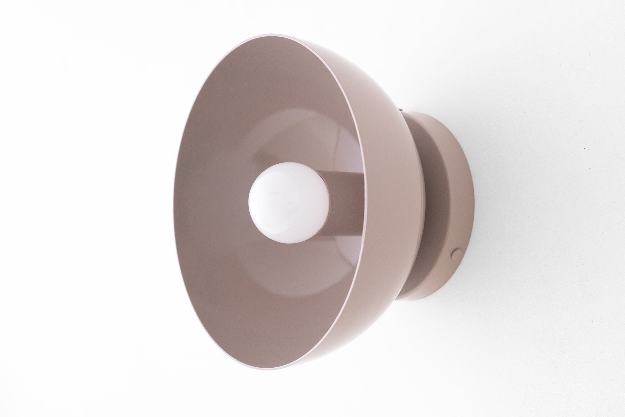 Flush Scandinavian-style wall sconce in mauve with a dome-shaped shade and exposed bulb. - SCONCE MODEL NO. 9105
