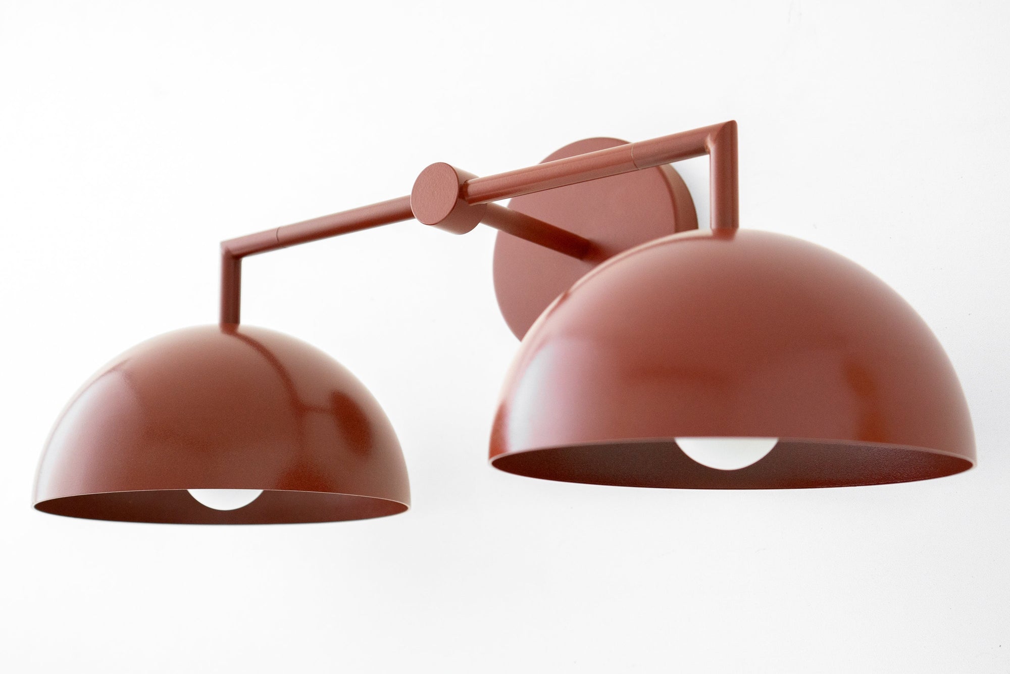 Art Deco two-bulb vanity light with matte brick red dome shades and geometric metal frame. - VANITY LIGHT MODEL NO. 6074