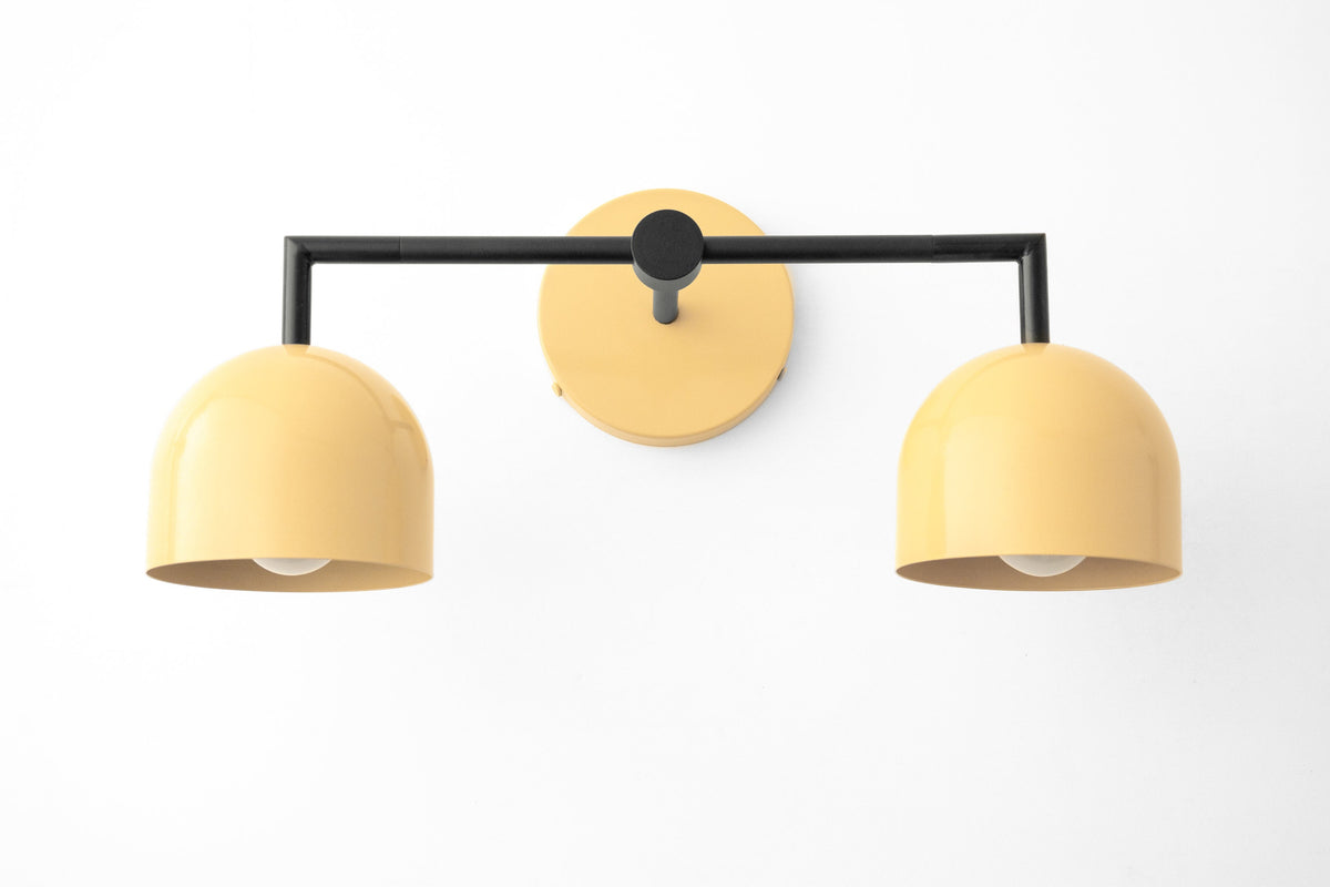 Black metal vanity light with two curved yellow shades in Art Deco style. - VANITY LIGHT MODEL NO. 8432