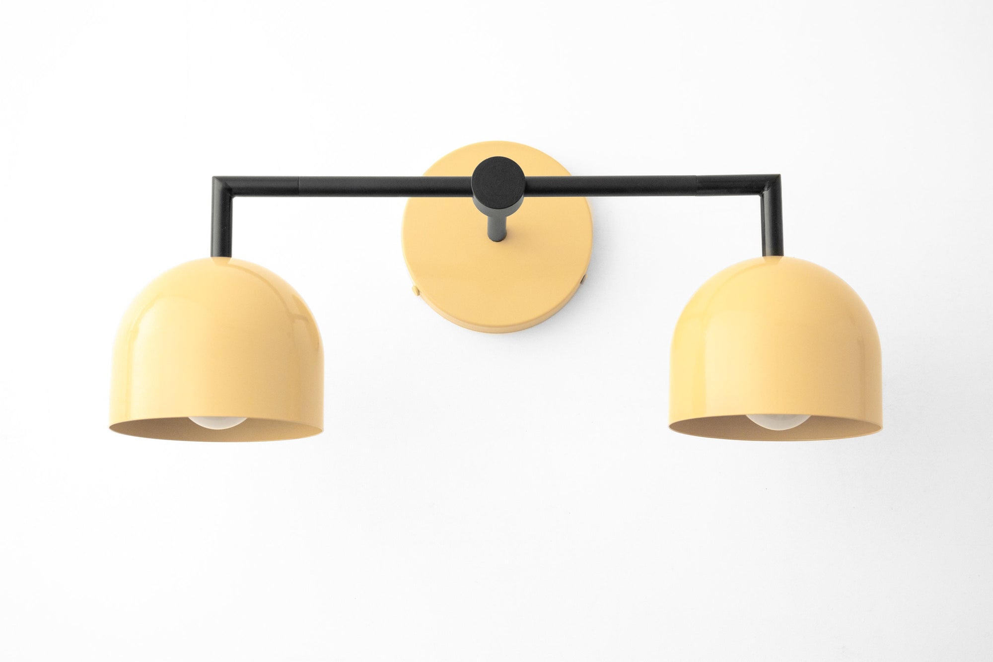 Black metal vanity light with two curved yellow shades in Art Deco style. - VANITY LIGHT MODEL NO. 8432