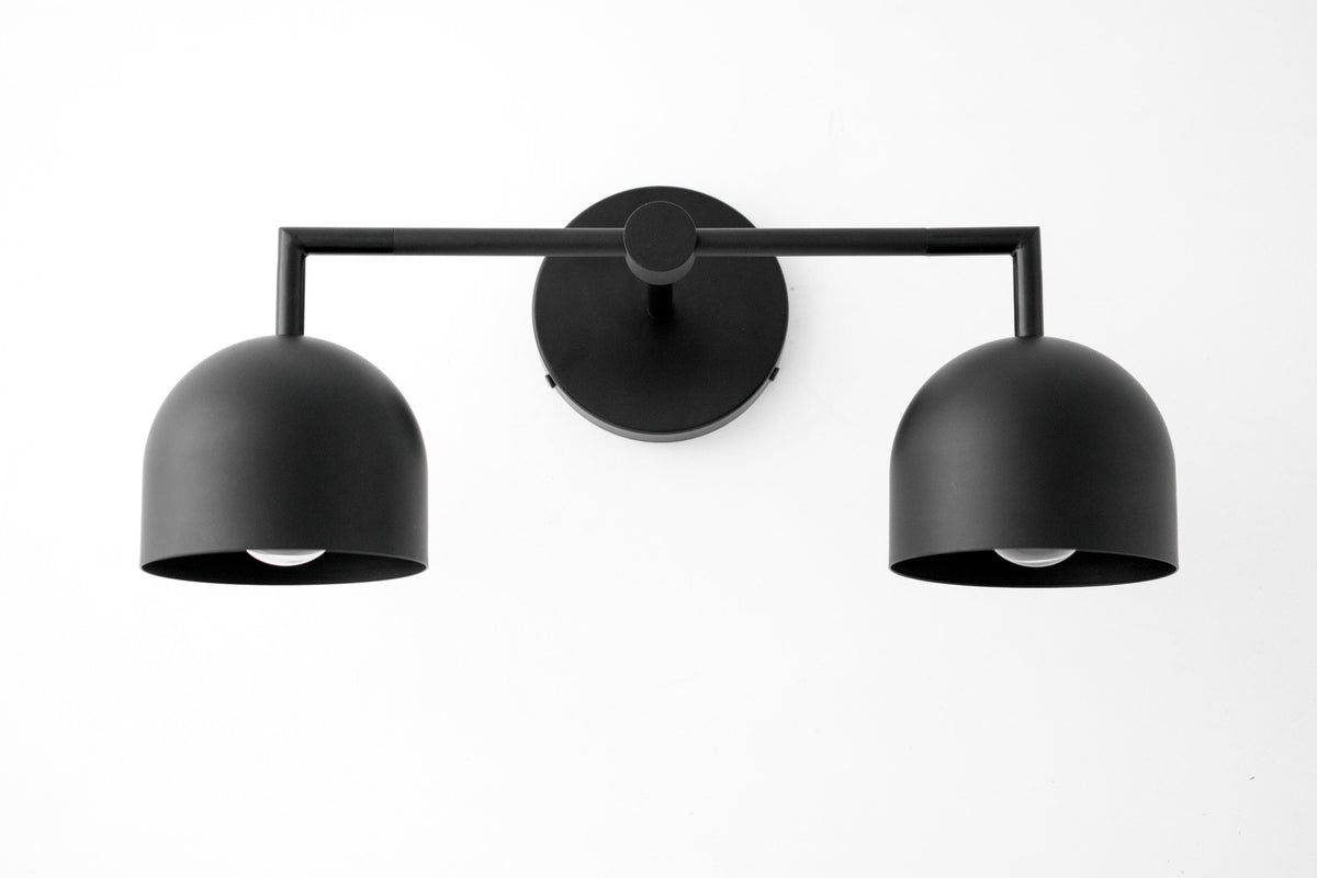 Matte black two-bulb vanity light with dome-shaped shades and horizontal bar mount. - VANITY LIGHT MODEL NO. 8432