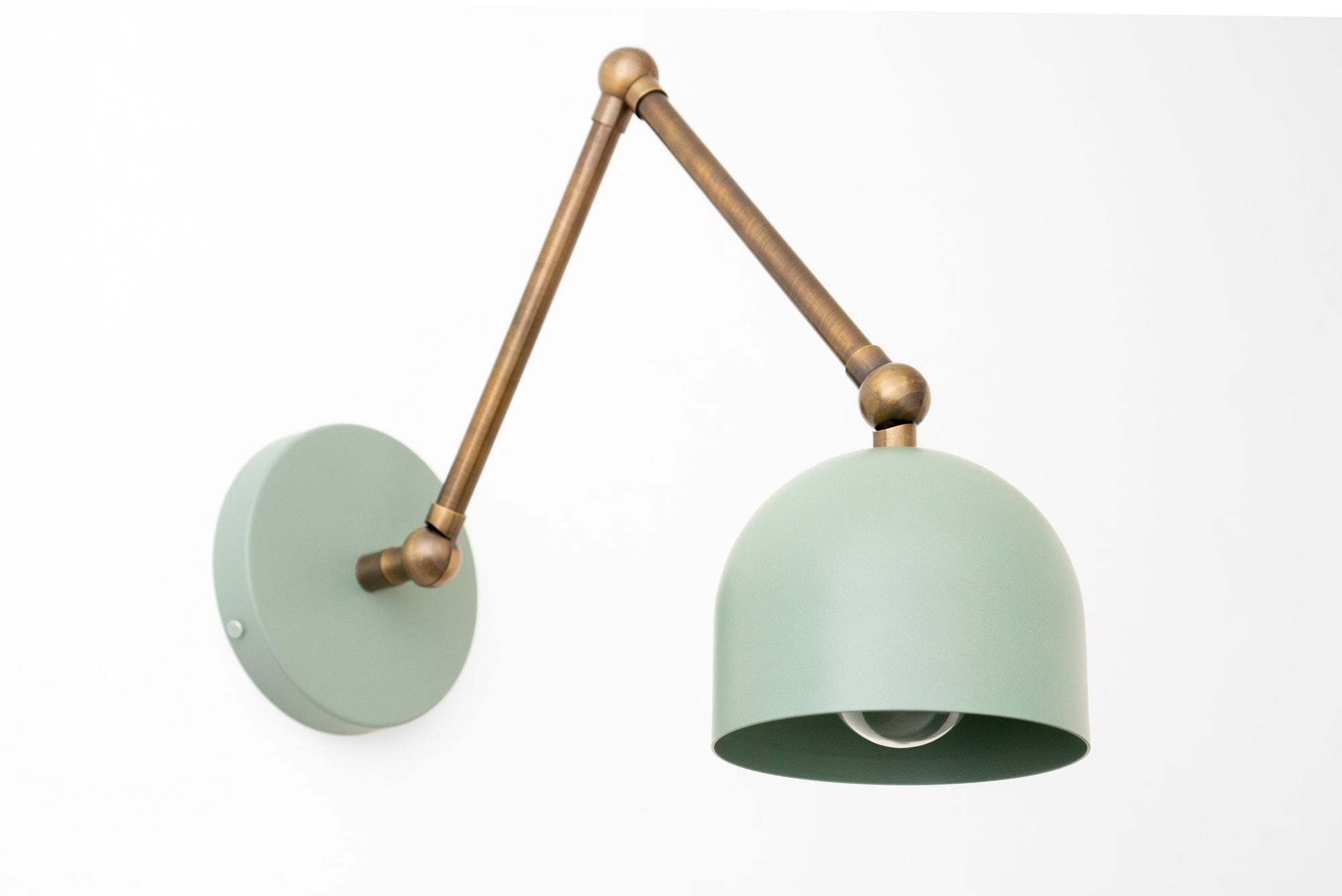 Adjustable antique brass wall sconce with matte light green dome shade and round wall mount. - SCONCE MODEL NO. 5998