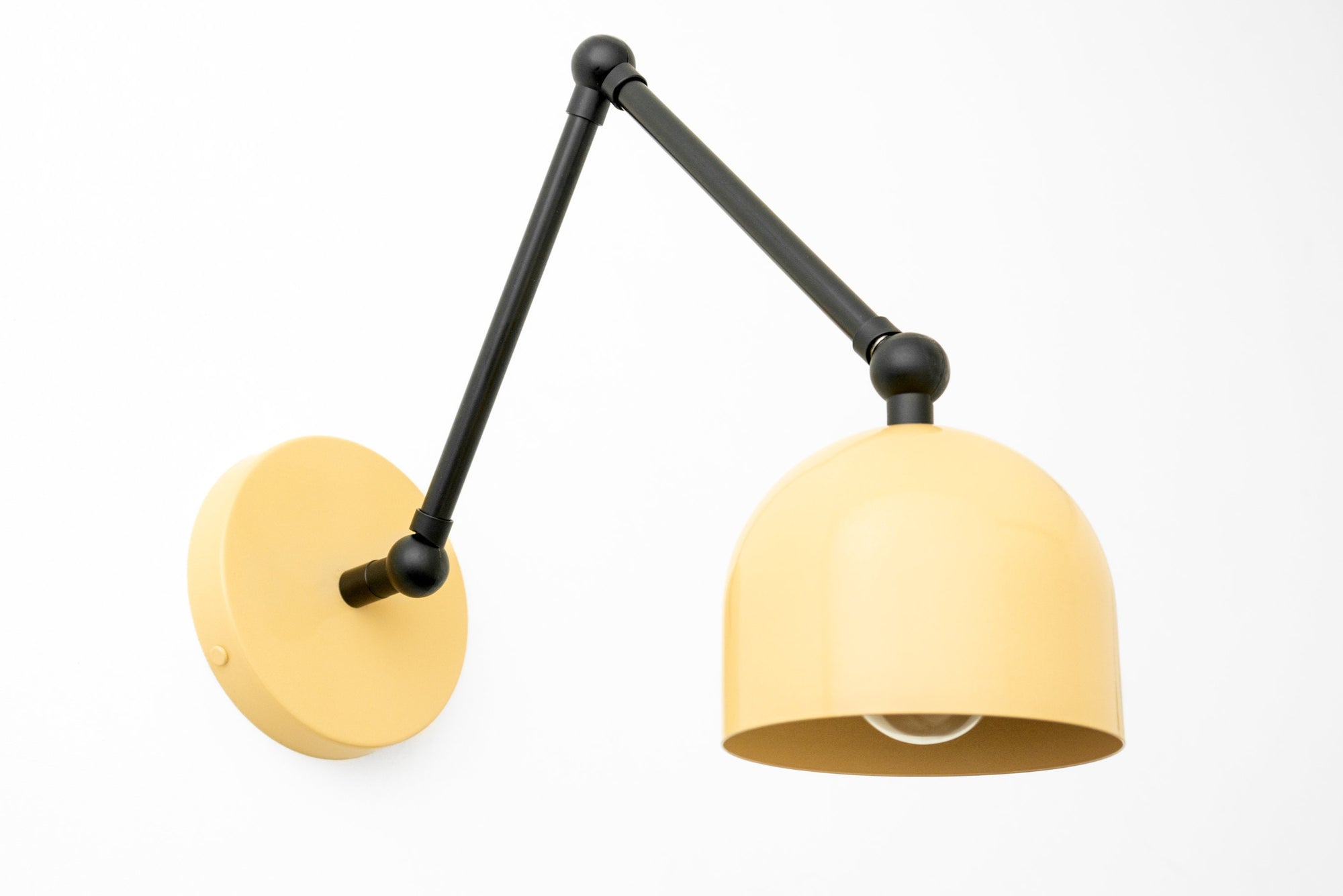 Black adjustable industrial sconce with a matte yellow dome shade and round wall mount. - SCONCE MODEL NO. 5998